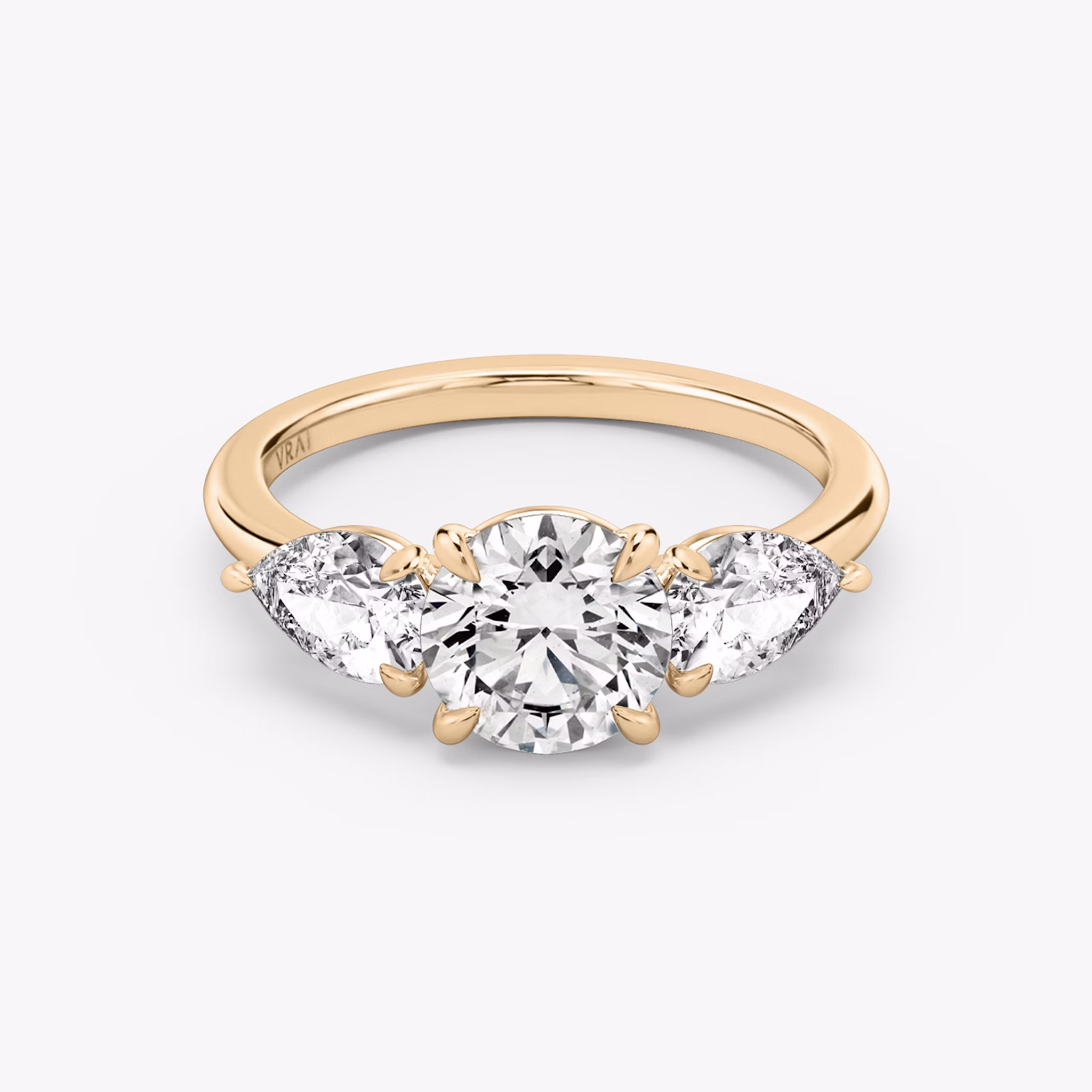 The Three Stone | Round Brilliant | 14k | Rose Gold | bandAccent: Plain | caratWeight: other | sideStoneCarat: 0.50ct | sideStoneShape: Pear | diamondOrientation: vertical