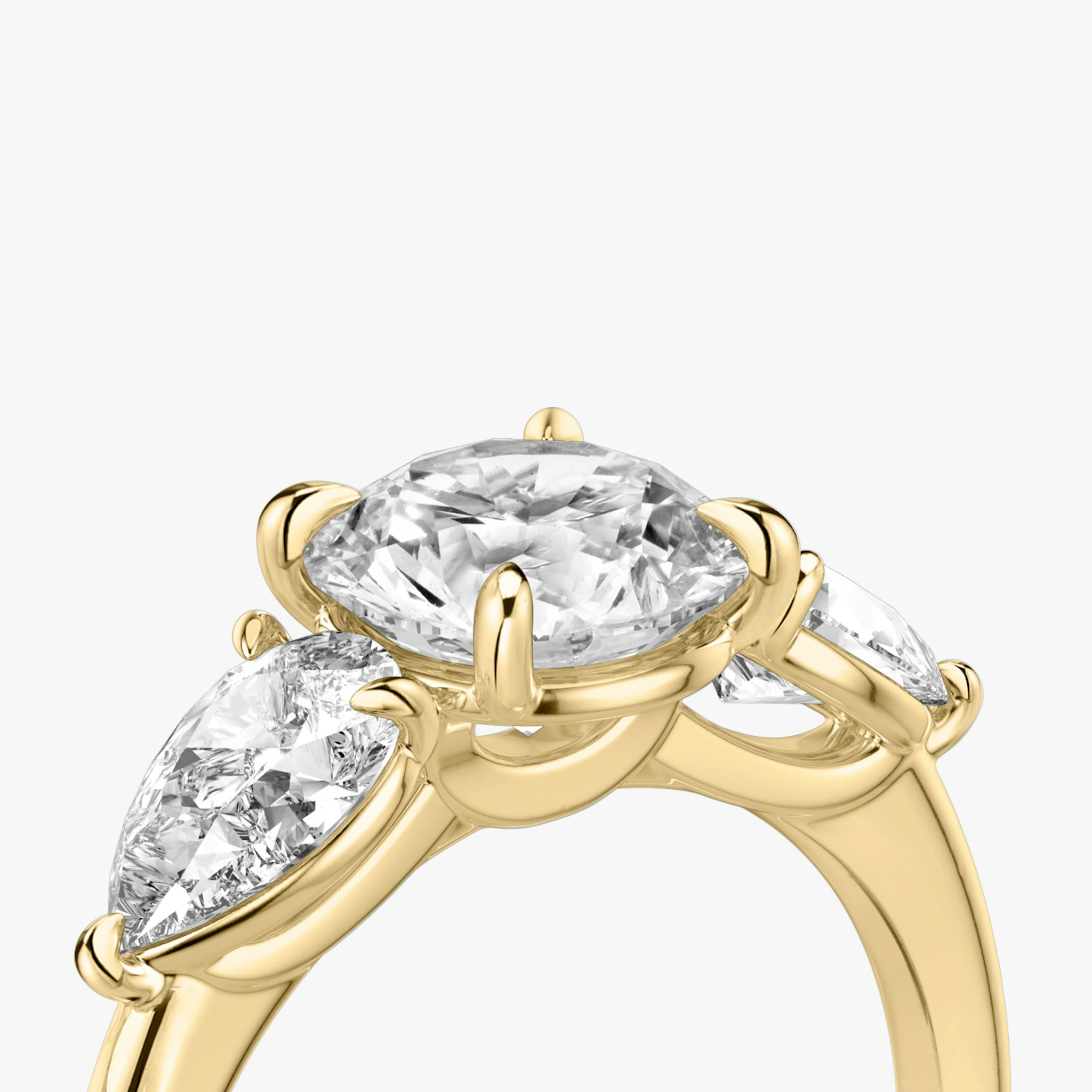The Three Stone | Round Brilliant | 18k | Yellow Gold | bandAccent: Plain | caratWeight: other | sideStoneCarat: 0.50ct | sideStoneShape: Pear | diamondOrientation: vertical