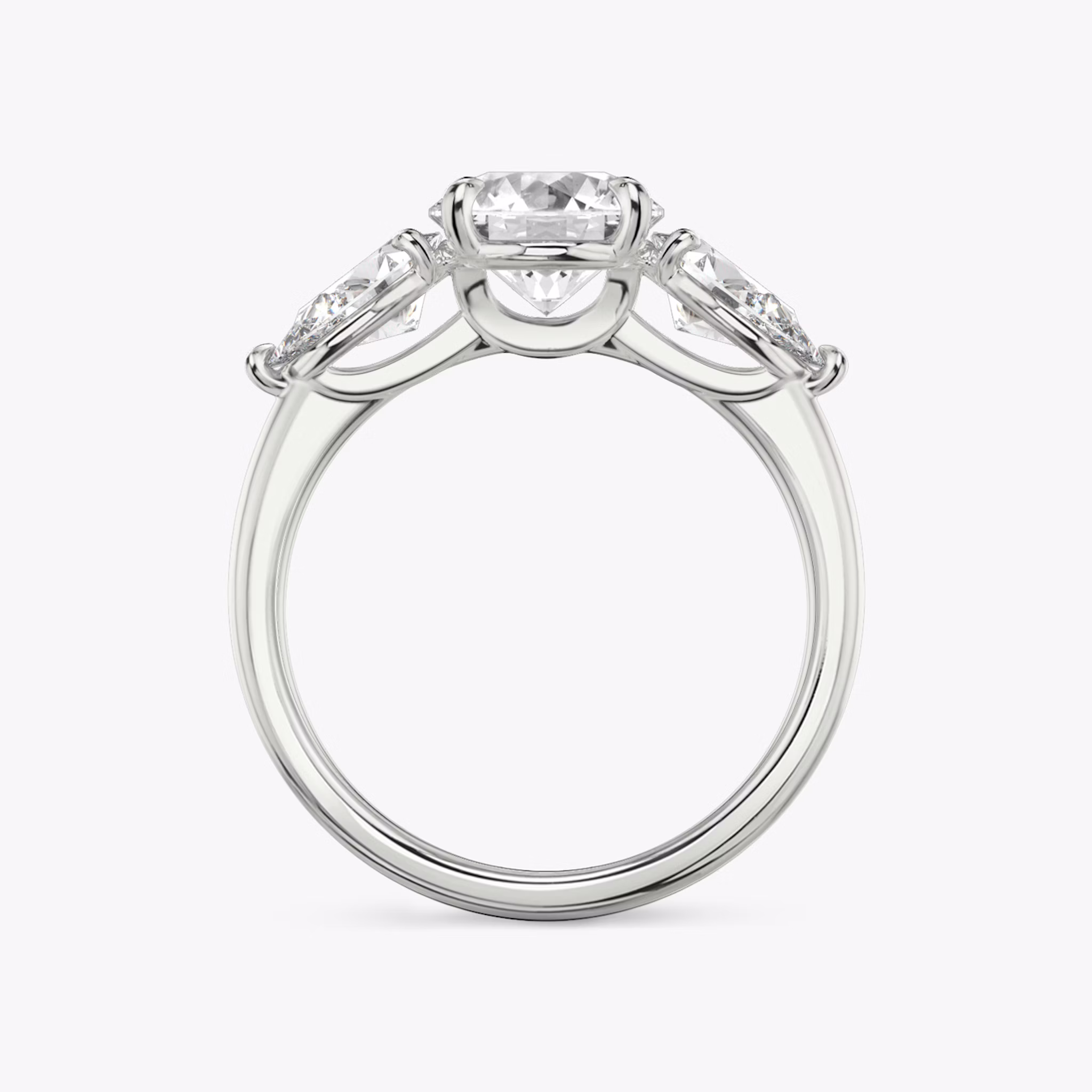 The Three Stone | Round Brilliant | 18k | White Gold | bandAccent: Plain | caratWeight: other | sideStoneCarat: 0.50ct | sideStoneShape: Pear | diamondOrientation: vertical