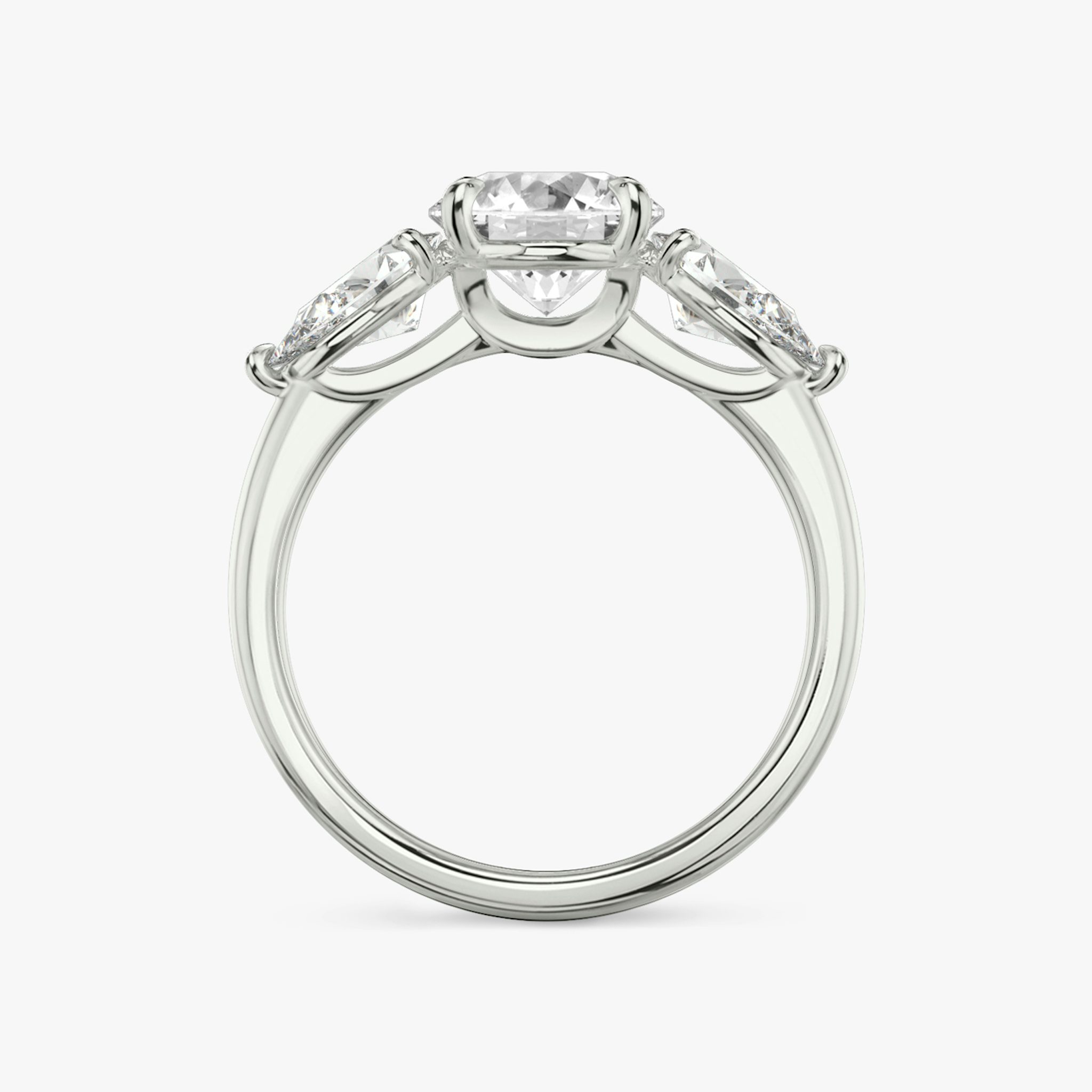 The Three Stone | Round Brilliant | 18k | White Gold | bandAccent: Plain | caratWeight: other | sideStoneCarat: 0.50ct | sideStoneShape: Pear | diamondOrientation: vertical