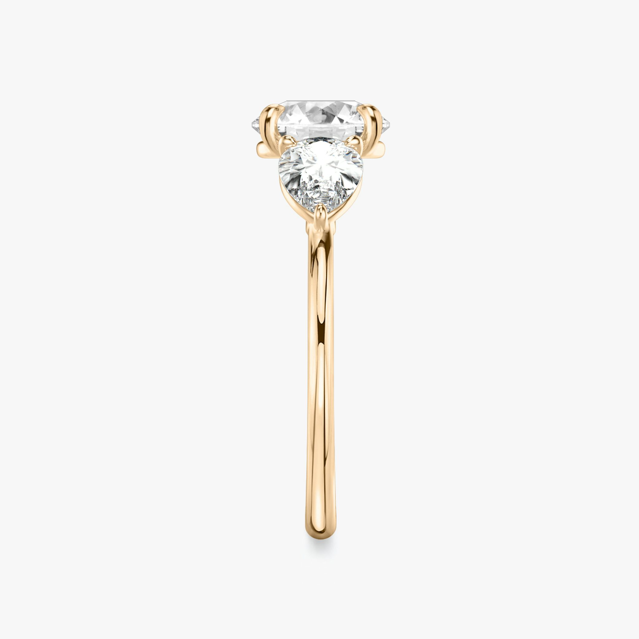The Three Stone | Round Brilliant | 14k | Rose Gold | bandAccent: Plain | caratWeight: other | sideStoneCarat: 0.50ct | sideStoneShape: Pear | diamondOrientation: vertical