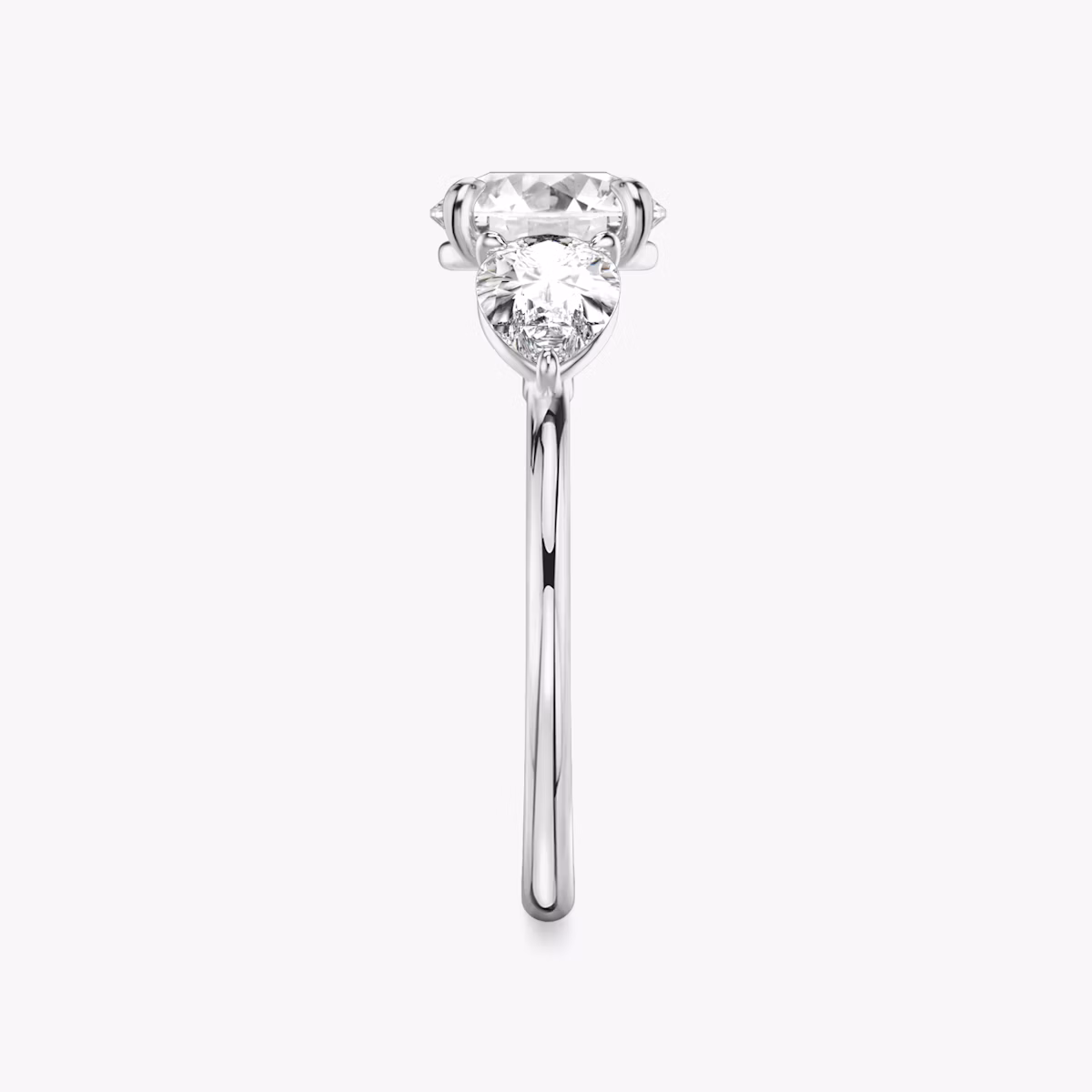 The Three Stone | Round Brilliant | Platinum | bandAccent: Plain | caratWeight: other | sideStoneCarat: 0.50ct | sideStoneShape: Pear | diamondOrientation: vertical