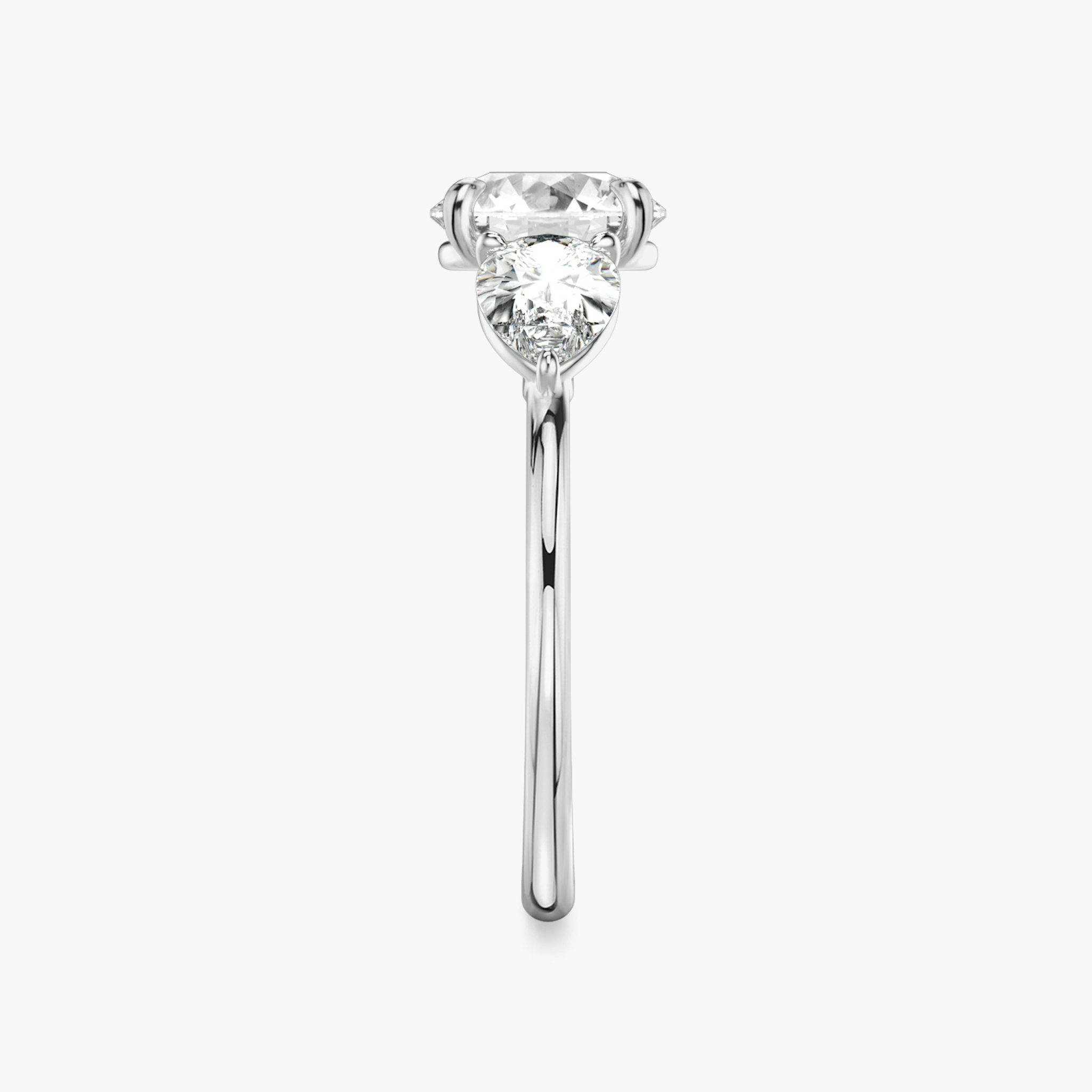 The Three Stone | Round Brilliant | 18k | White Gold | bandAccent: Plain | caratWeight: other | sideStoneCarat: 0.50ct | sideStoneShape: Pear | diamondOrientation: vertical