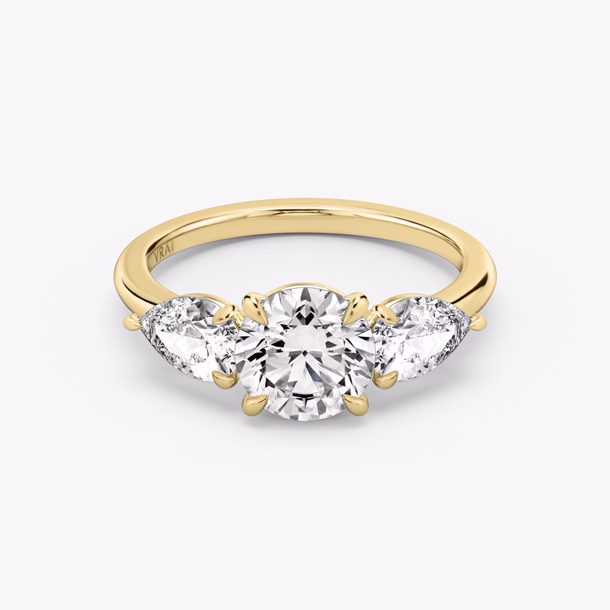 The Three Stone | Round Brilliant | 18k | Yellow Gold | bandAccent: Plain | caratWeight: other | sideStoneCarat: 0.50ct | sideStoneShape: Pear | diamondOrientation: vertical