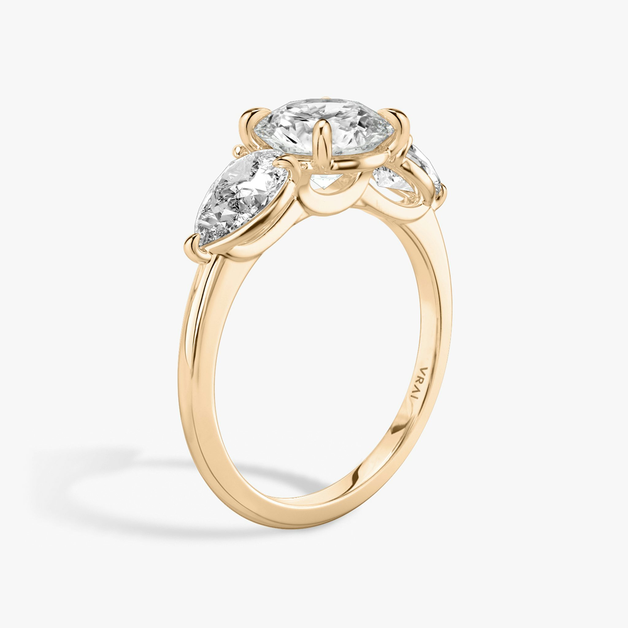The Three Stone | Round Brilliant | 14k | Rose Gold | bandAccent: Plain | caratWeight: other | sideStoneCarat: 0.50ct | sideStoneShape: Pear | diamondOrientation: vertical