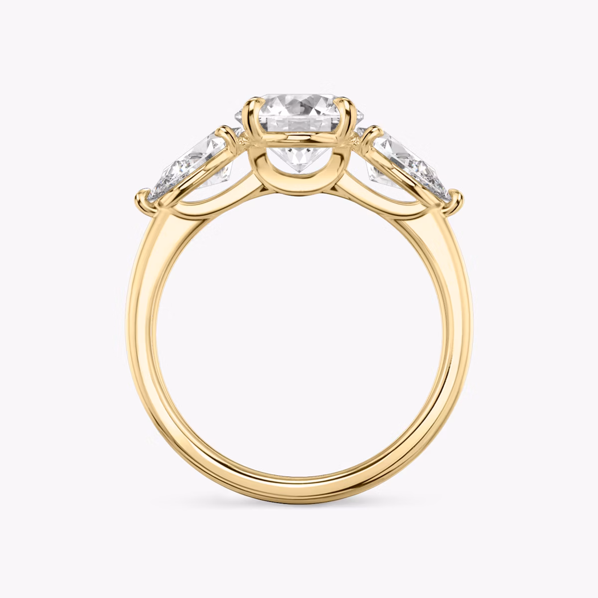 The Three Stone | Round Brilliant | 18k | Yellow Gold | bandAccent: Plain | caratWeight: other | sideStoneCarat: 0.50ct | sideStoneShape: Pear | diamondOrientation: vertical