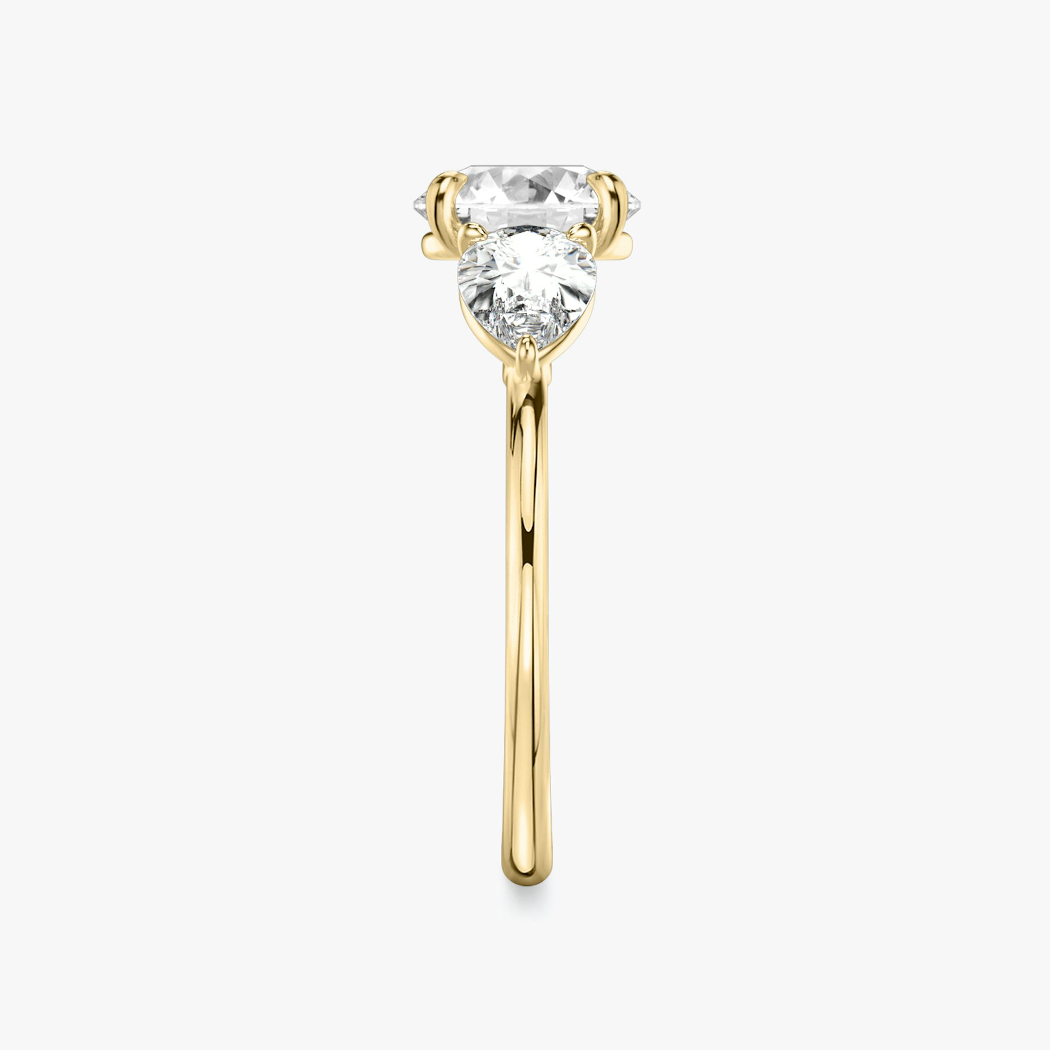 The Three Stone | Round Brilliant | 18k | Yellow Gold | bandAccent: Plain | caratWeight: other | sideStoneCarat: 0.50ct | sideStoneShape: Pear | diamondOrientation: vertical