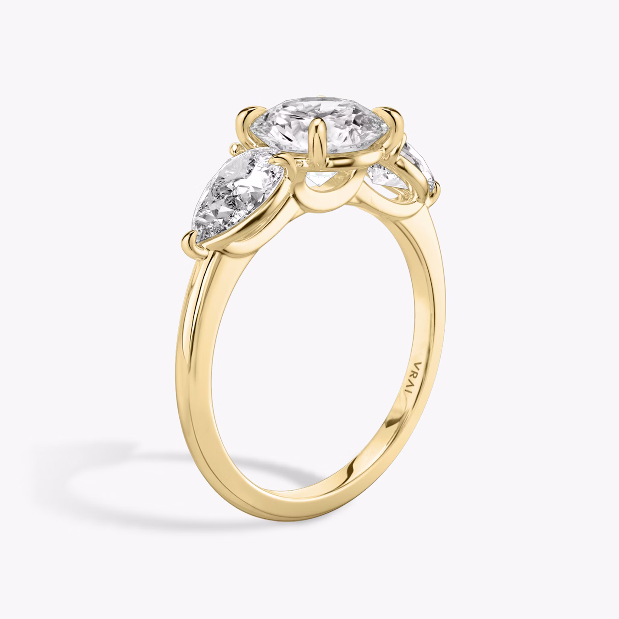 The Three Stone | Round Brilliant | 18k | Yellow Gold | bandAccent: Plain | caratWeight: other | sideStoneCarat: 0.50ct | sideStoneShape: Pear | diamondOrientation: vertical