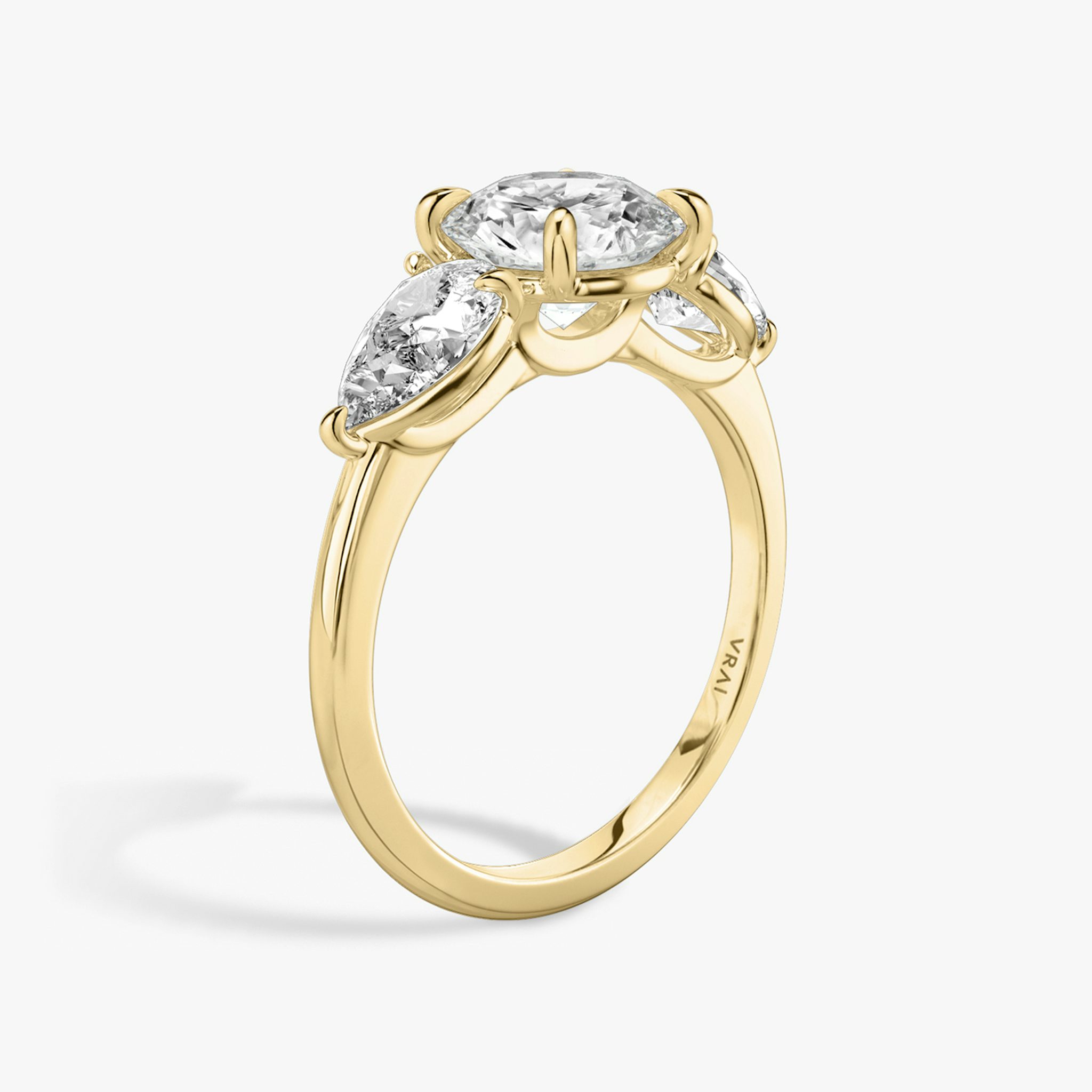 The Three Stone | Round Brilliant | 18k | Yellow Gold | bandAccent: Plain | caratWeight: other | sideStoneCarat: 0.50ct | sideStoneShape: Pear | diamondOrientation: vertical