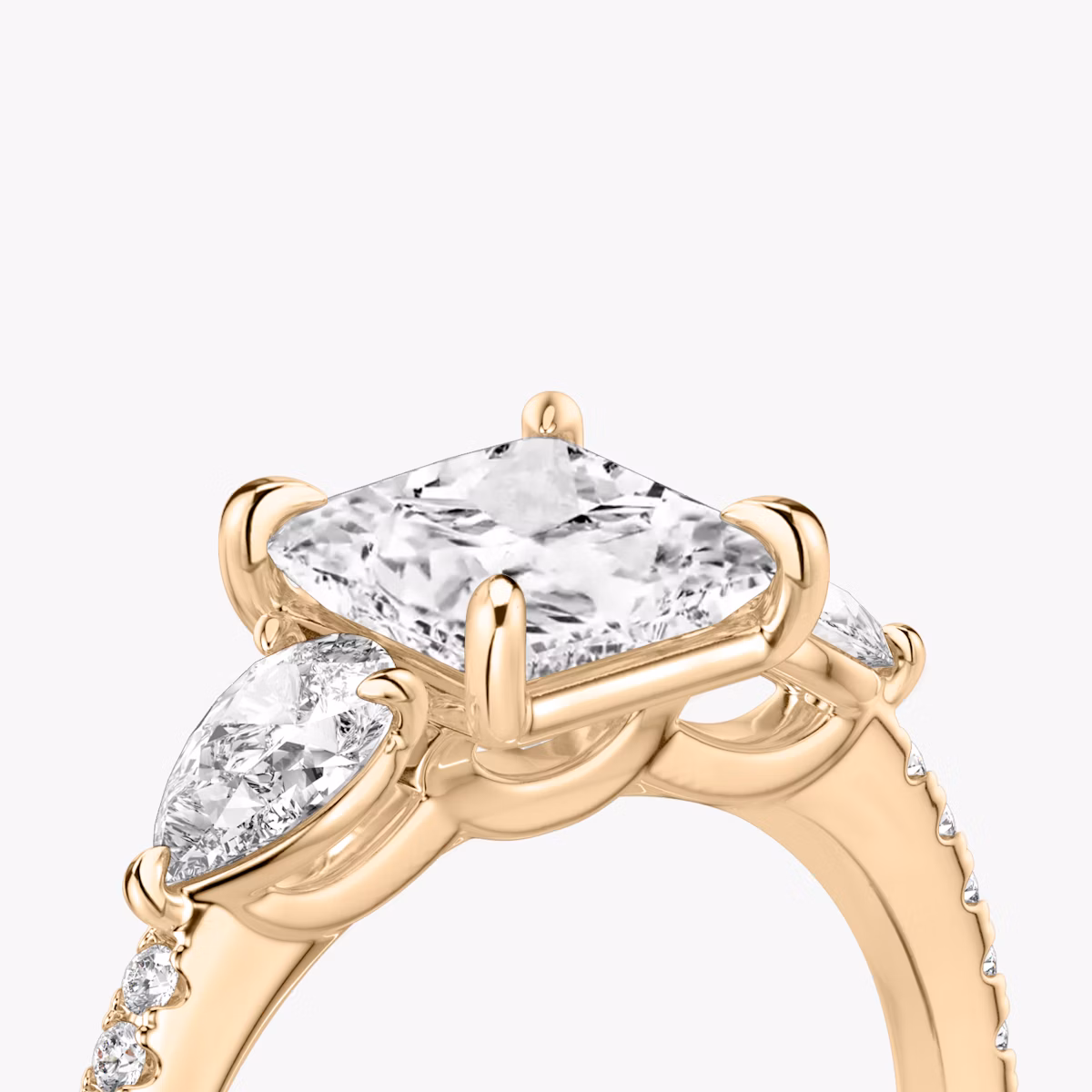 The Three Stone | Princess | 14k | Rose Gold | bandAccent: Pavé | sideStoneCarat: 0.25ct | sideStoneShape: Pear | diamondOrientation: vertical | caratWeight: other