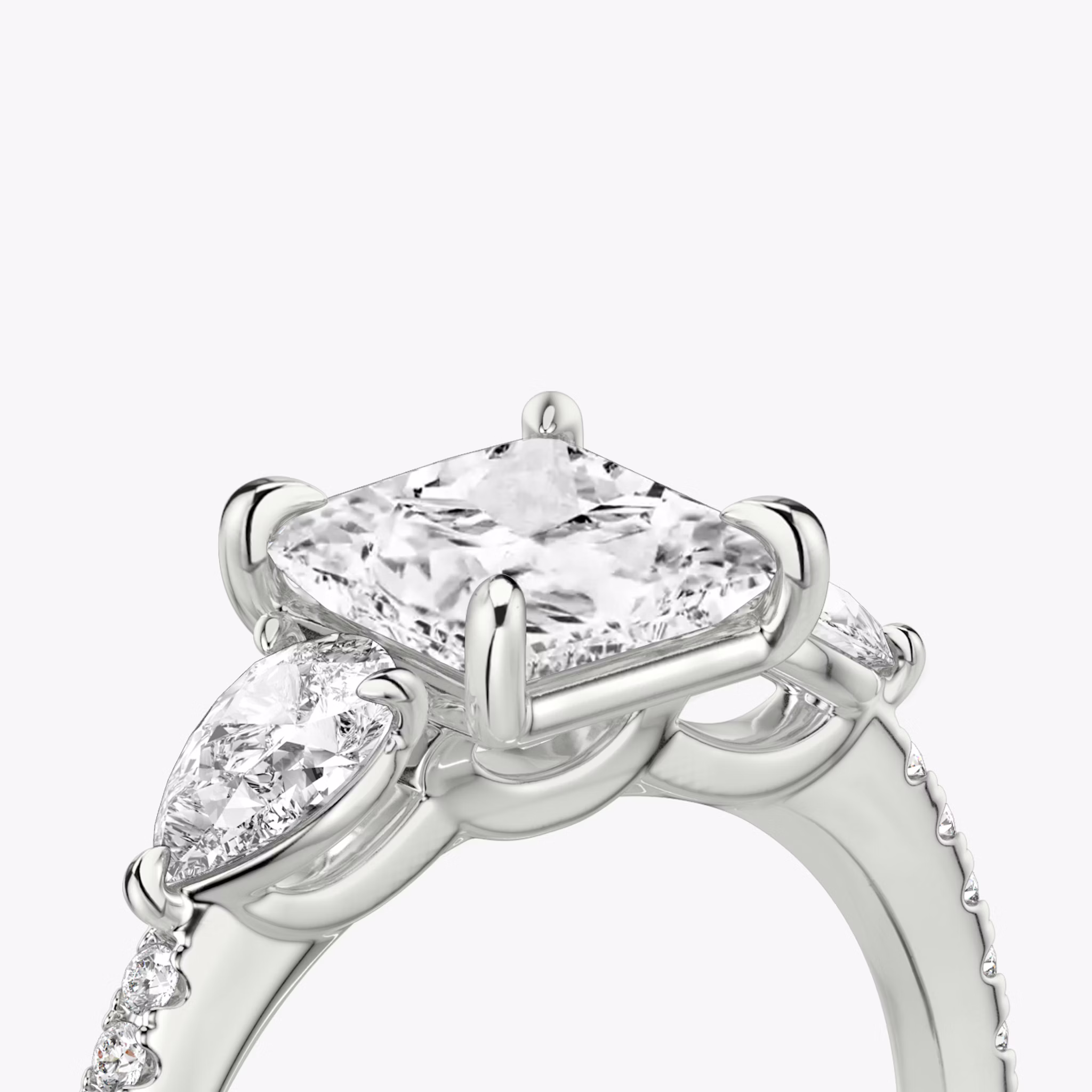 The Three Stone | Princess | 18k | White Gold | bandAccent: Pavé | sideStoneCarat: 0.25ct | sideStoneShape: Pear | diamondOrientation: vertical | caratWeight: other