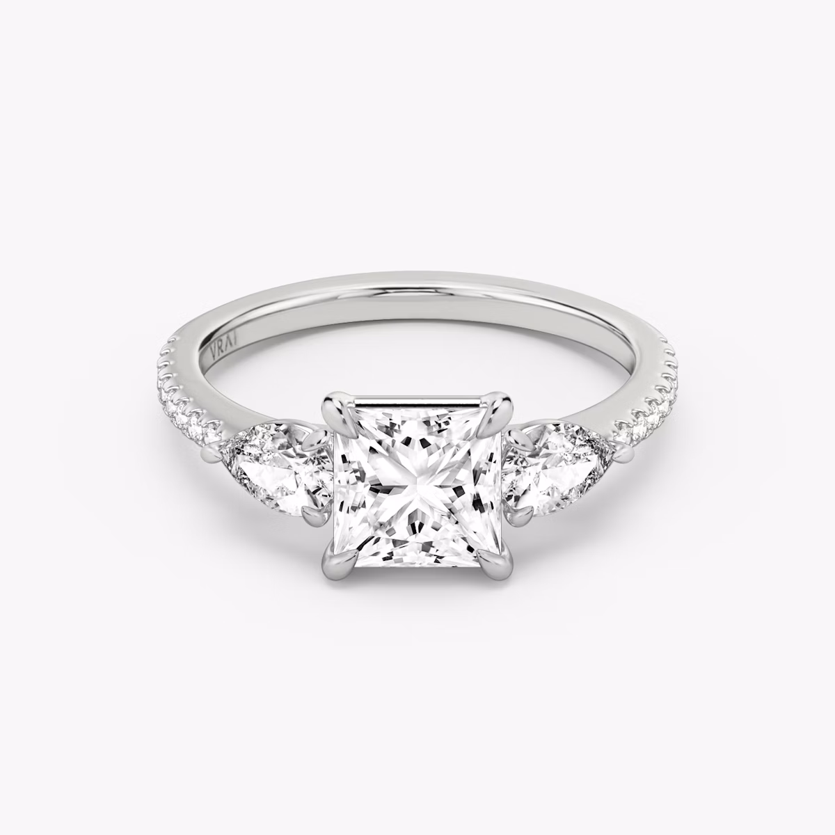 The Three Stone | Princess | Platinum | bandAccent: Pavé | sideStoneCarat: 0.25ct | sideStoneShape: Pear | diamondOrientation: vertical | caratWeight: other