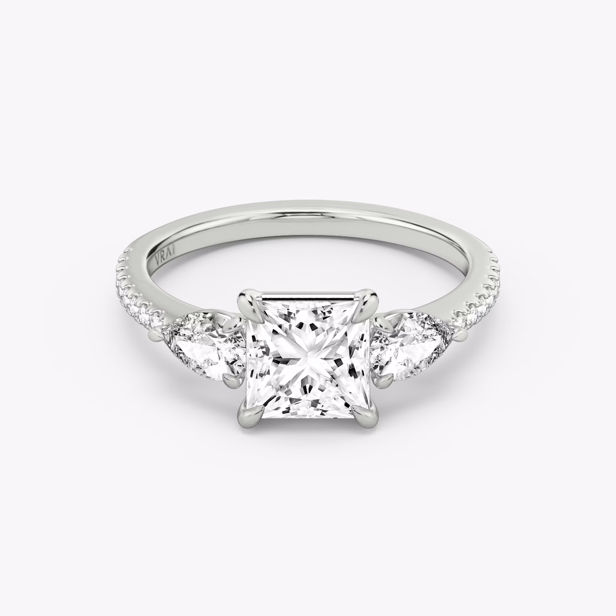 The Three Stone | Princess | 18k | White Gold | bandAccent: Pavé | sideStoneCarat: 0.25ct | sideStoneShape: Pear | diamondOrientation: vertical | caratWeight: other