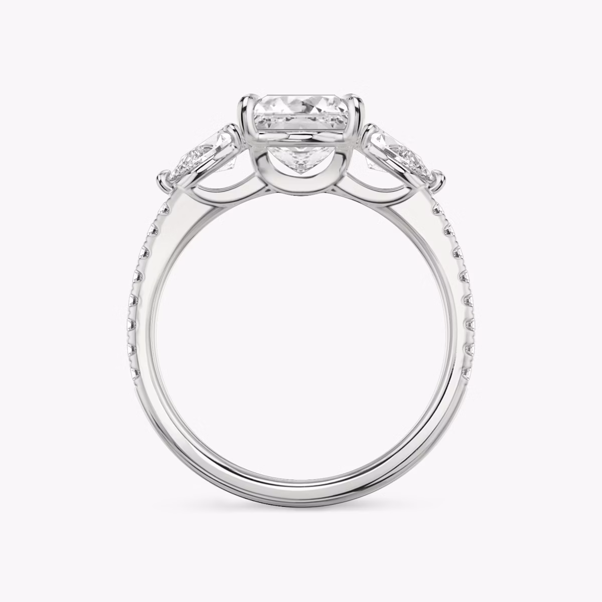 The Three Stone | Princess | Platinum | bandAccent: Pavé | sideStoneCarat: 0.25ct | sideStoneShape: Pear | diamondOrientation: vertical | caratWeight: other