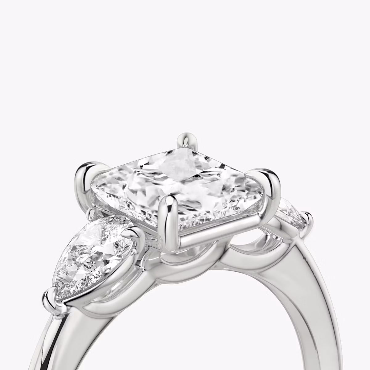 The Three Stone | Princess | Platinum | bandAccent: Plain | sideStoneCarat: 0.25ct | sideStoneShape: Pear | diamondOrientation: vertical | caratWeight: other
