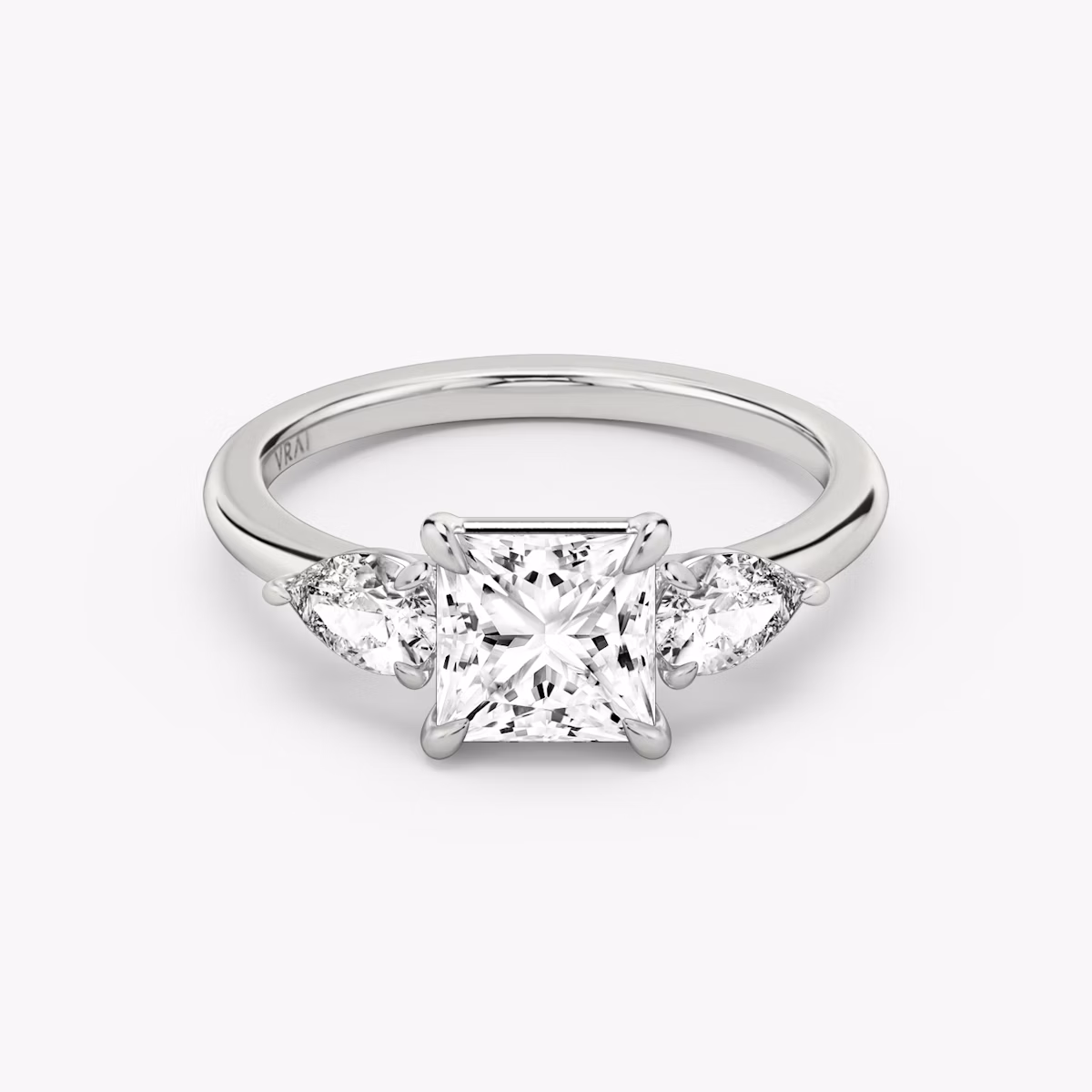 The Three Stone | Princess | Platinum | bandAccent: Plain | sideStoneCarat: 0.25ct | sideStoneShape: Pear | diamondOrientation: vertical | caratWeight: other