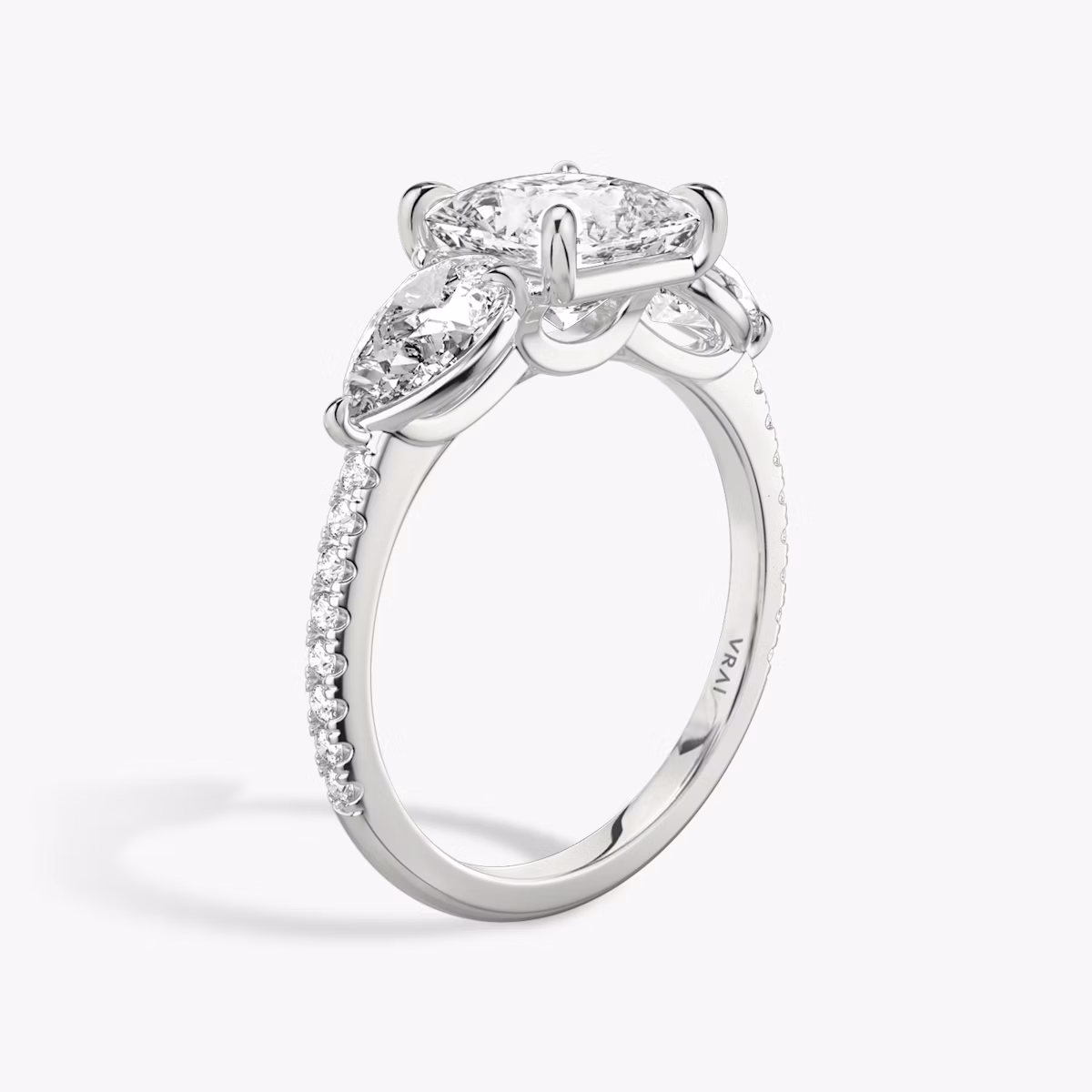 The Three Stone | Princess | Platinum | bandAccent: Pavé | sideStoneCarat: 0.50ct | sideStoneShape: Pear | diamondOrientation: vertical | caratWeight: other