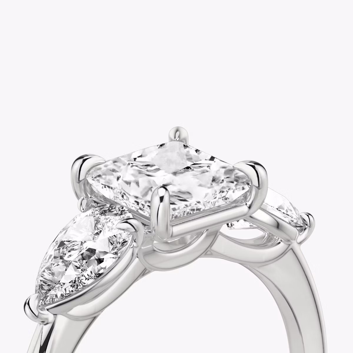 The Three Stone | Princess | Platinum | bandAccent: Plain | sideStoneCarat: 0.50ct | sideStoneShape: Pear | diamondOrientation: vertical | caratWeight: other