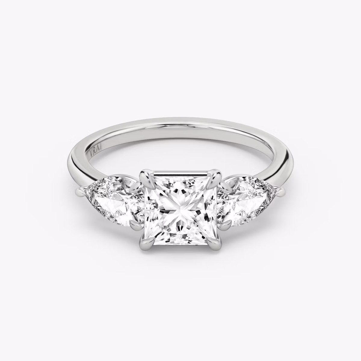 The Three Stone | Princess | Platinum | bandAccent: Plain | sideStoneCarat: 0.50ct | sideStoneShape: Pear | diamondOrientation: vertical | caratWeight: other