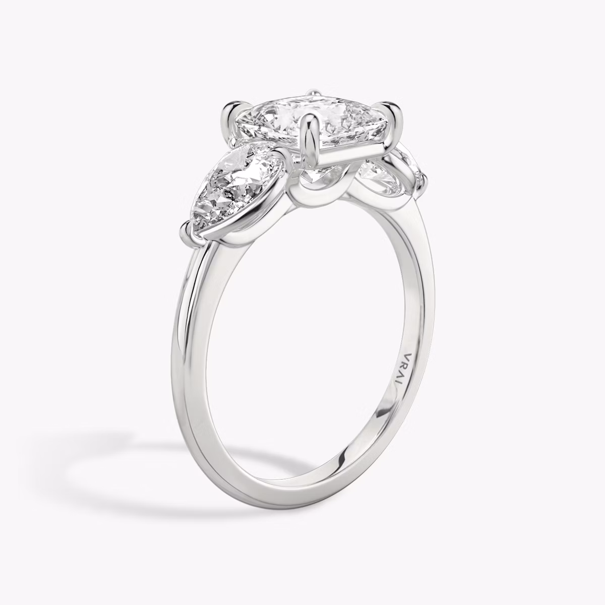 The Three Stone | Princess | Platinum | bandAccent: Plain | sideStoneCarat: 0.50ct | sideStoneShape: Pear | diamondOrientation: vertical | caratWeight: other