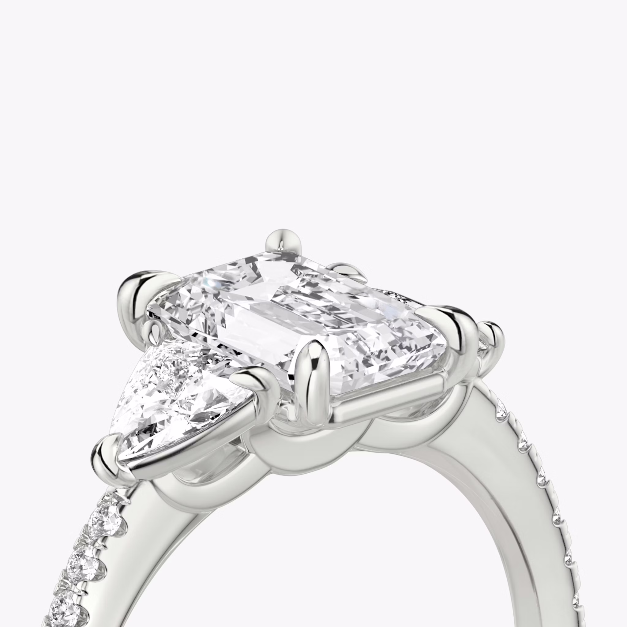 The Three Stone | Emerald | 18k | White Gold | bandAccent: Pavé | sideStoneCarat: 0.25ct | sideStoneShape: Trillion | diamondOrientation: vertical | caratWeight: other