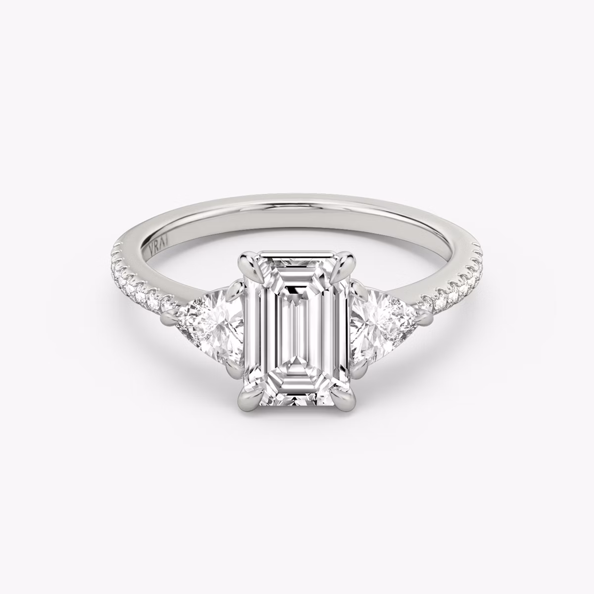 The Three Stone | Emerald | Platinum | bandAccent: Pavé | sideStoneCarat: 0.25ct | sideStoneShape: Trillion | diamondOrientation: vertical | caratWeight: other