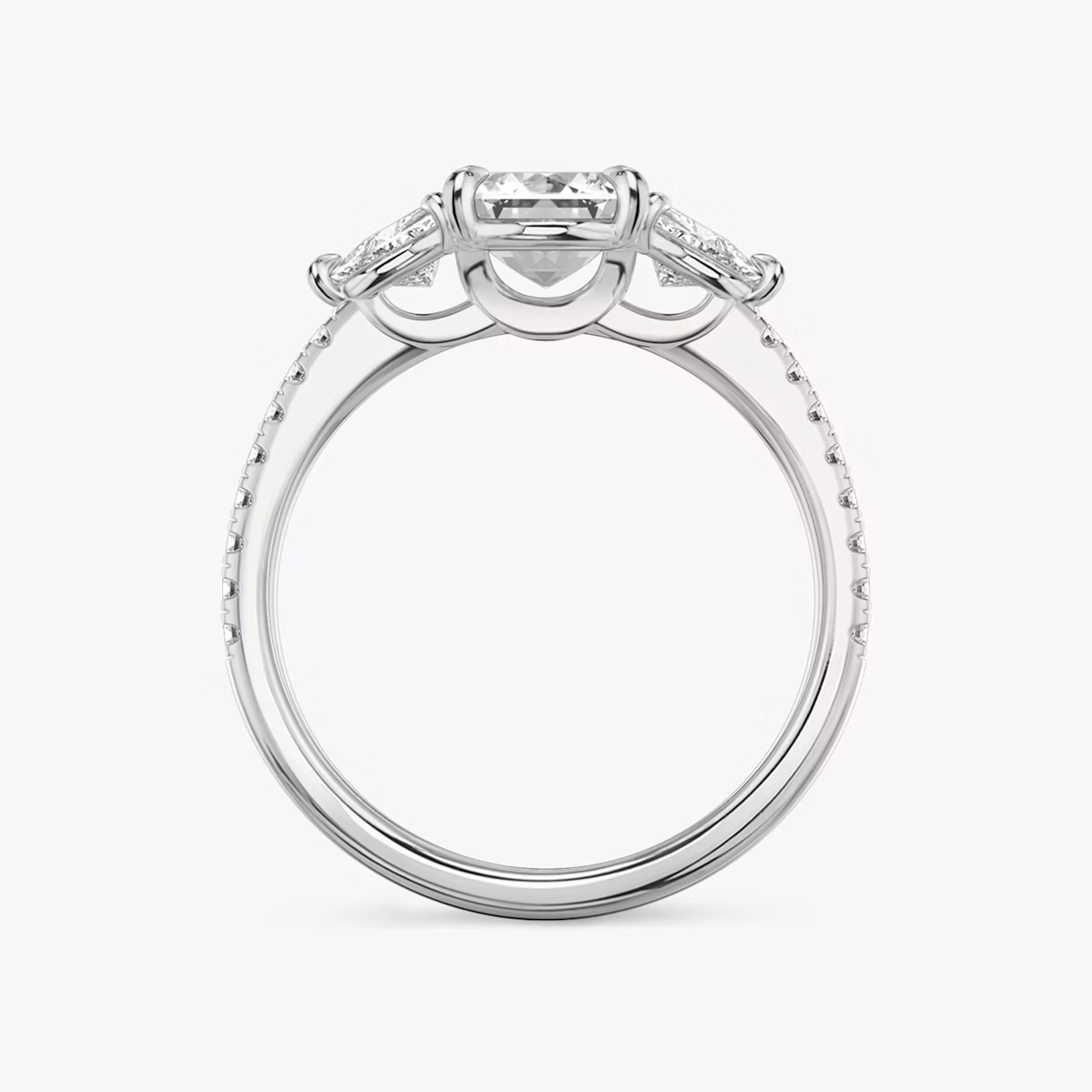 The Three Stone | Emerald | Platinum | bandAccent: Pavé | sideStoneCarat: 0.25ct | sideStoneShape: Trillion | diamondOrientation: vertical | caratWeight: other