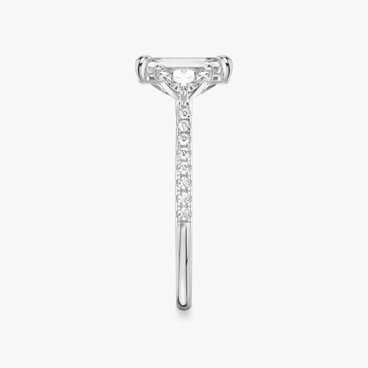 The Three Stone | Emerald | Platinum | bandAccent: Pavé | sideStoneCarat: 0.25ct | sideStoneShape: Trillion | diamondOrientation: vertical | caratWeight: other