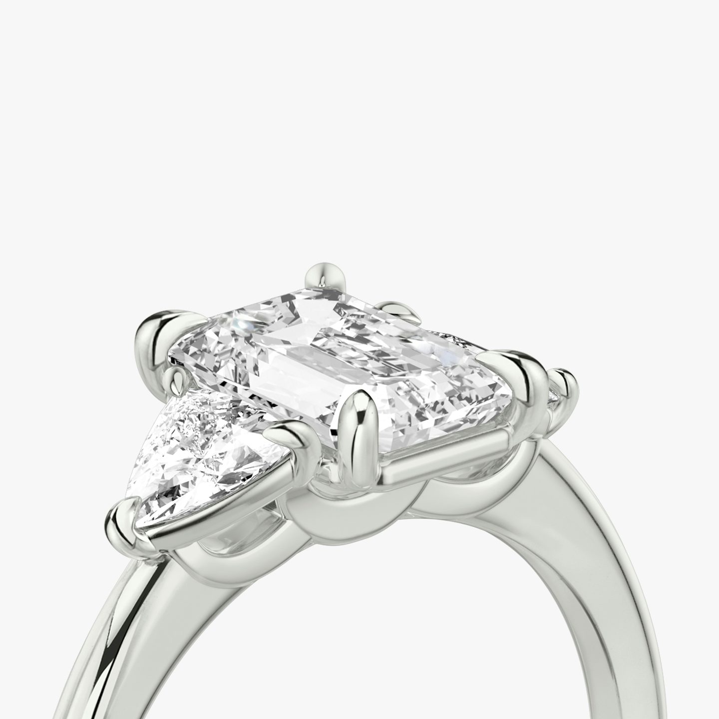 The Three Stone | Emerald | Platinum | bandAccent: Plain | sideStoneCarat: 0.25ct | sideStoneShape: Trillion | diamondOrientation: vertical | caratWeight: other