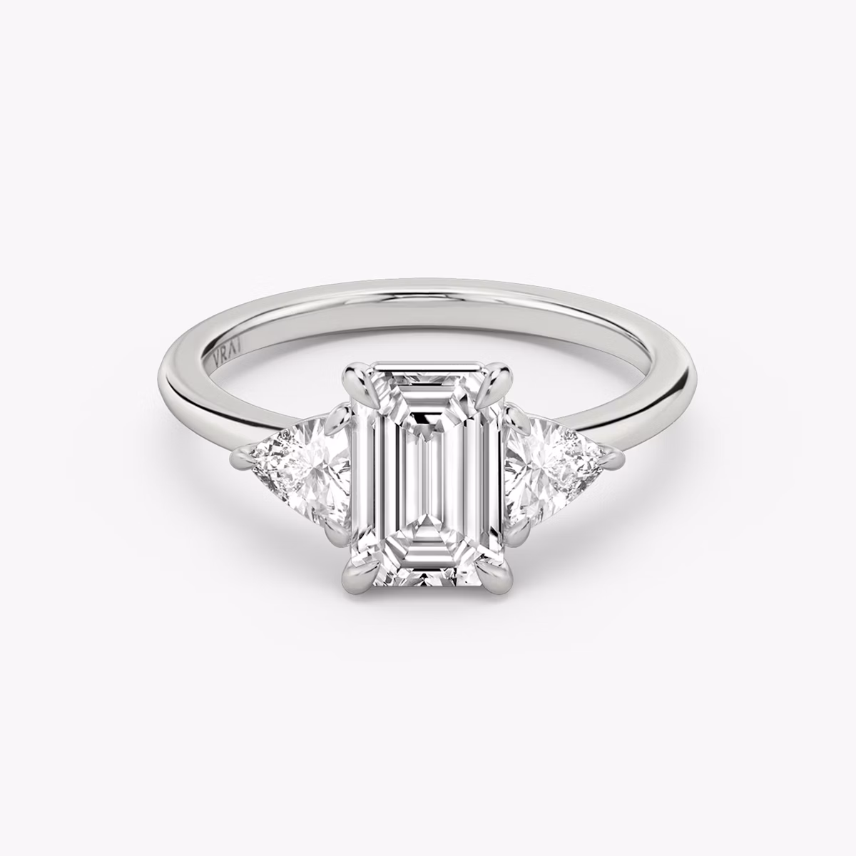 The Three Stone | Emerald | Platinum | bandAccent: Plain | sideStoneCarat: 0.25ct | sideStoneShape: Trillion | diamondOrientation: vertical | caratWeight: other