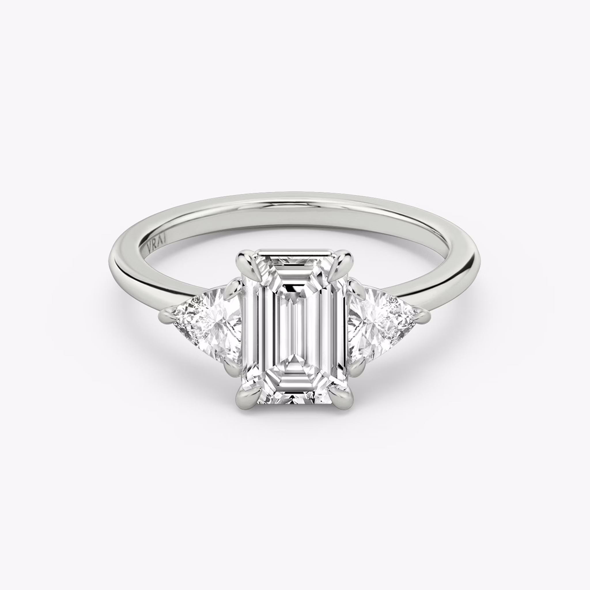 The Three Stone | Emerald | 18k | White Gold | bandAccent: Plain | sideStoneCarat: 0.25ct | sideStoneShape: Trillion | diamondOrientation: vertical | caratWeight: other