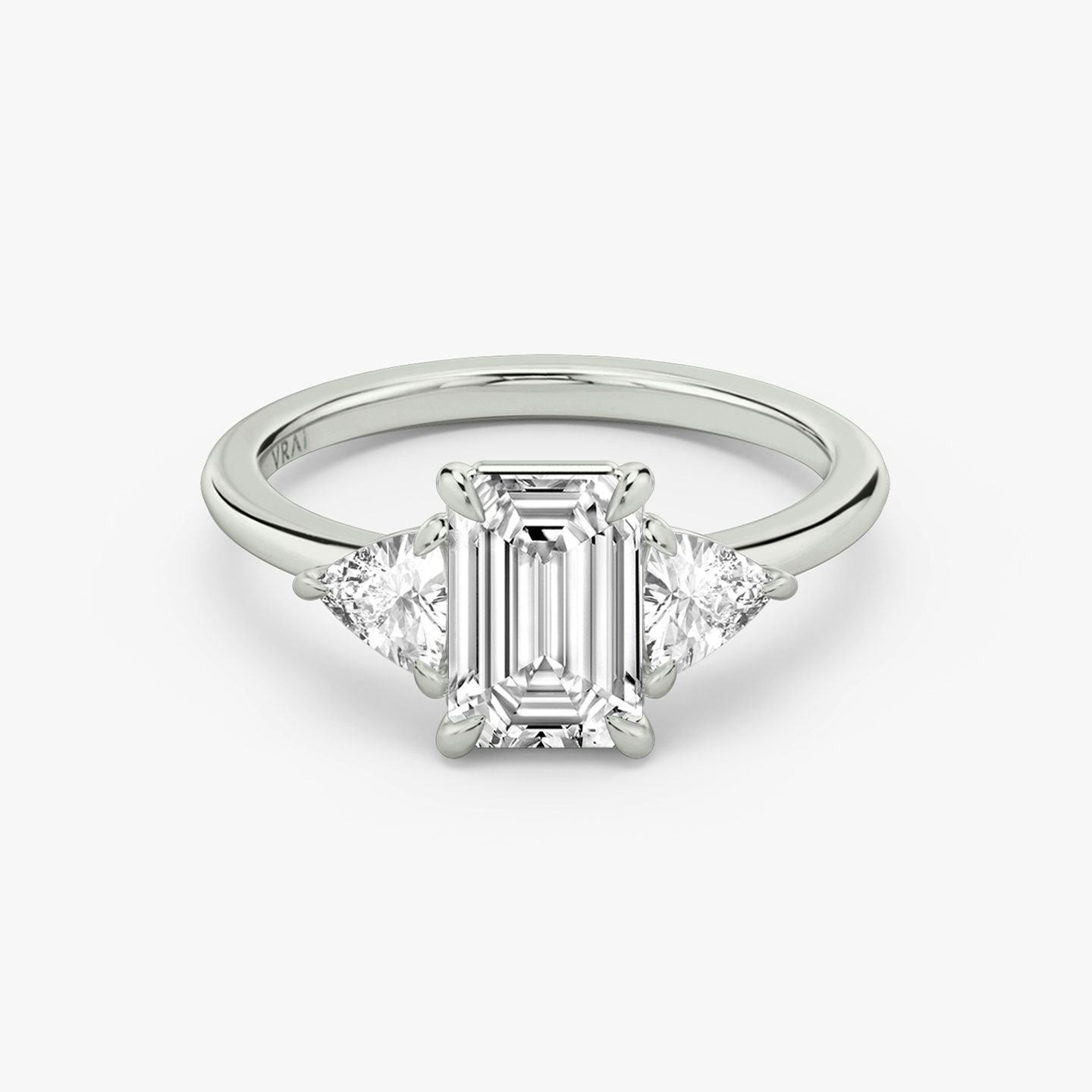 The Three Stone | Emerald | Platinum | bandAccent: Plain | sideStoneCarat: 0.25ct | sideStoneShape: Trillion | diamondOrientation: vertical | caratWeight: other