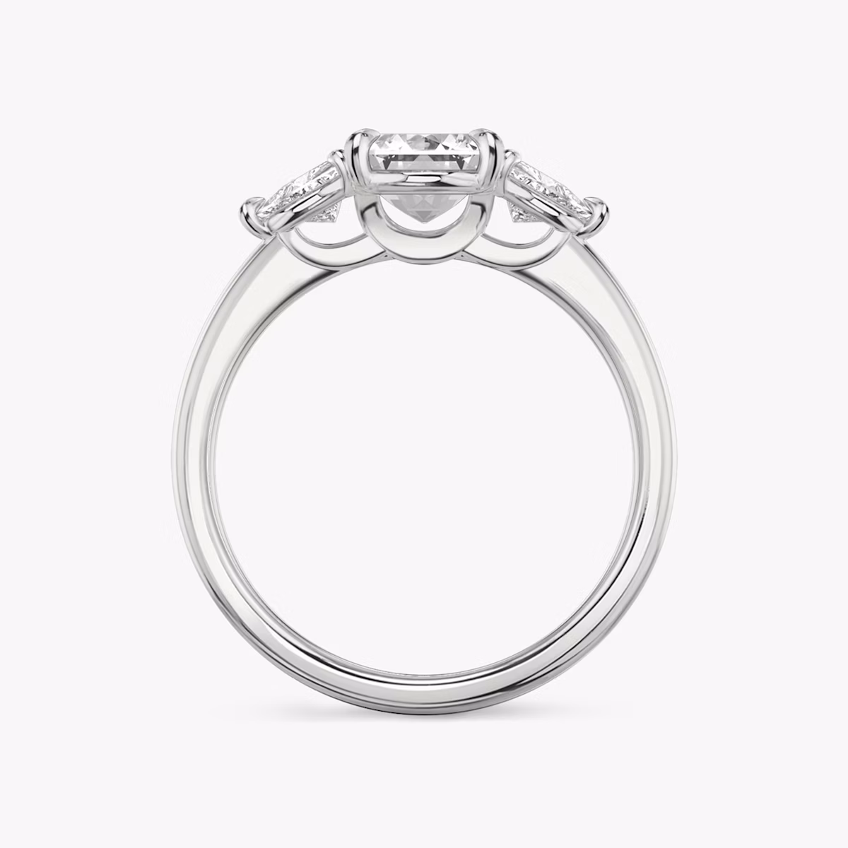 The Three Stone | Emerald | Platinum | bandAccent: Plain | sideStoneCarat: 0.25ct | sideStoneShape: Trillion | diamondOrientation: vertical | caratWeight: other