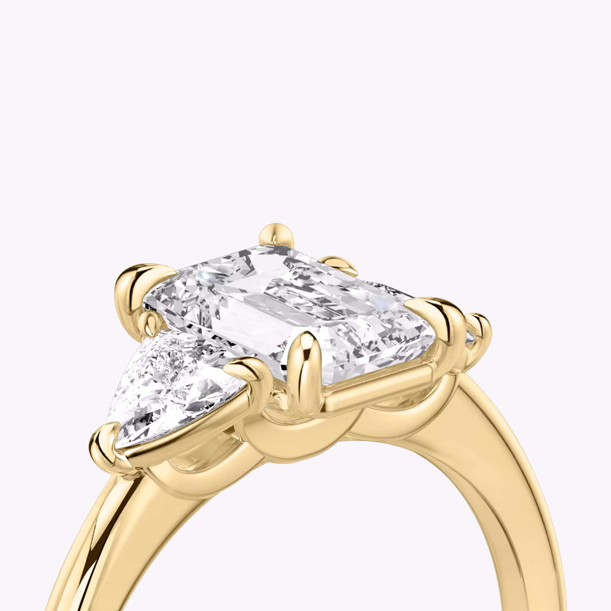 The Three Stone | Emerald | 18k | Yellow Gold | bandAccent: Plain | sideStoneCarat: 0.25ct | sideStoneShape: Trillion | diamondOrientation: vertical | caratWeight: other