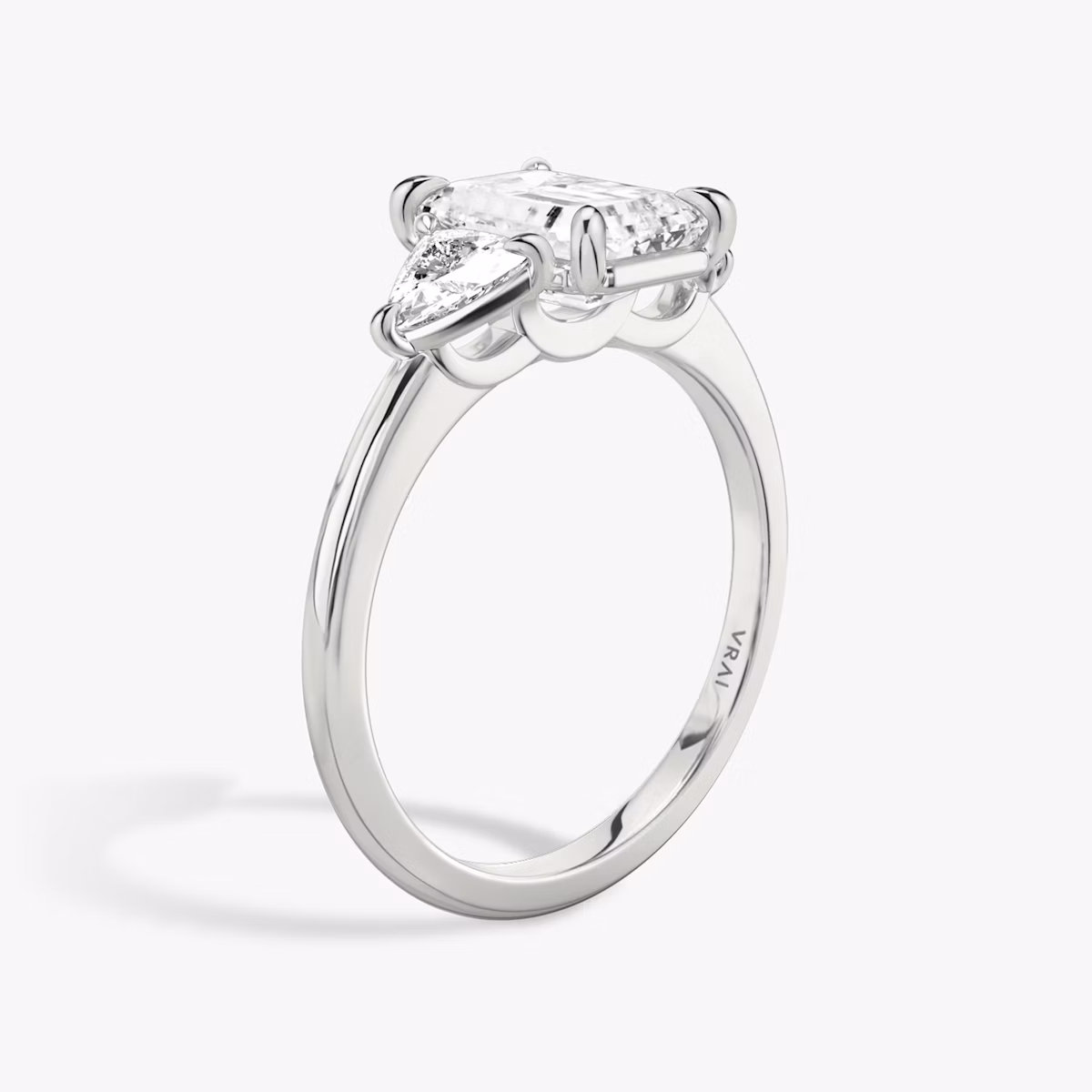 The Three Stone | Emerald | Platinum | bandAccent: Plain | sideStoneCarat: 0.25ct | sideStoneShape: Trillion | diamondOrientation: vertical | caratWeight: other