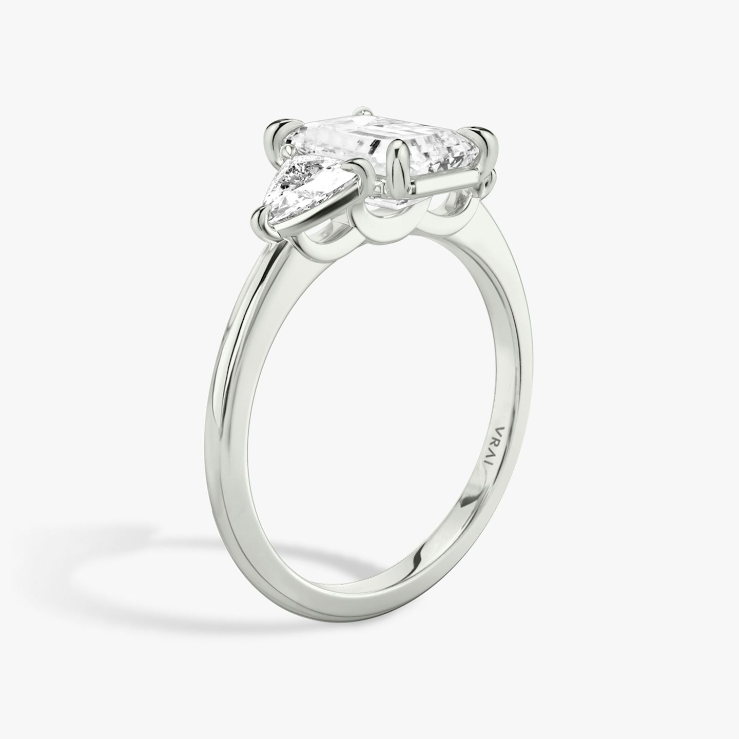 The Three Stone | Emerald | Platinum | bandAccent: Plain | sideStoneCarat: 0.25ct | sideStoneShape: Trillion | diamondOrientation: vertical | caratWeight: other