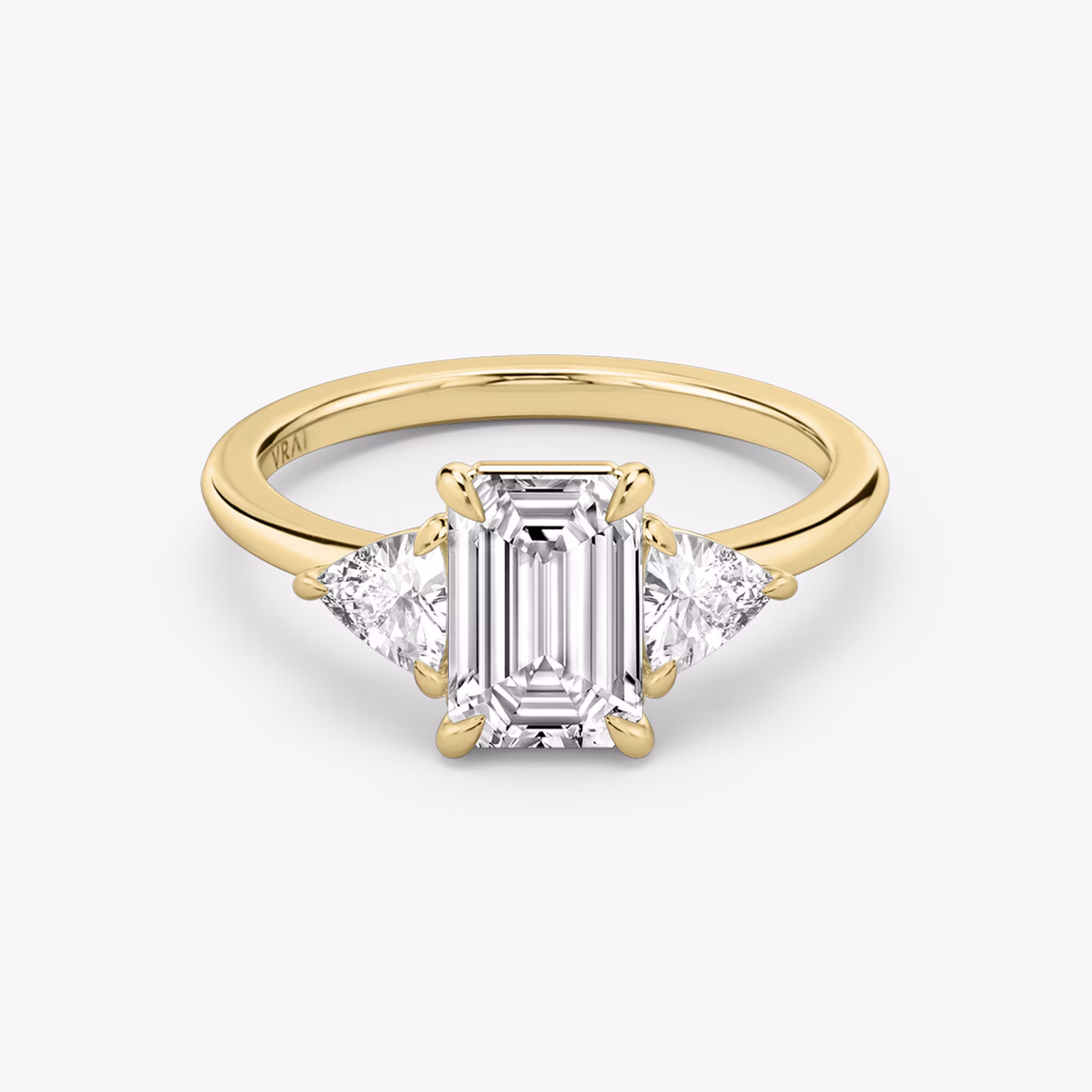 The Three Stone | Emerald | 18k | Yellow Gold | bandAccent: Plain | sideStoneCarat: 0.25ct | sideStoneShape: Trillion | diamondOrientation: vertical | caratWeight: other
