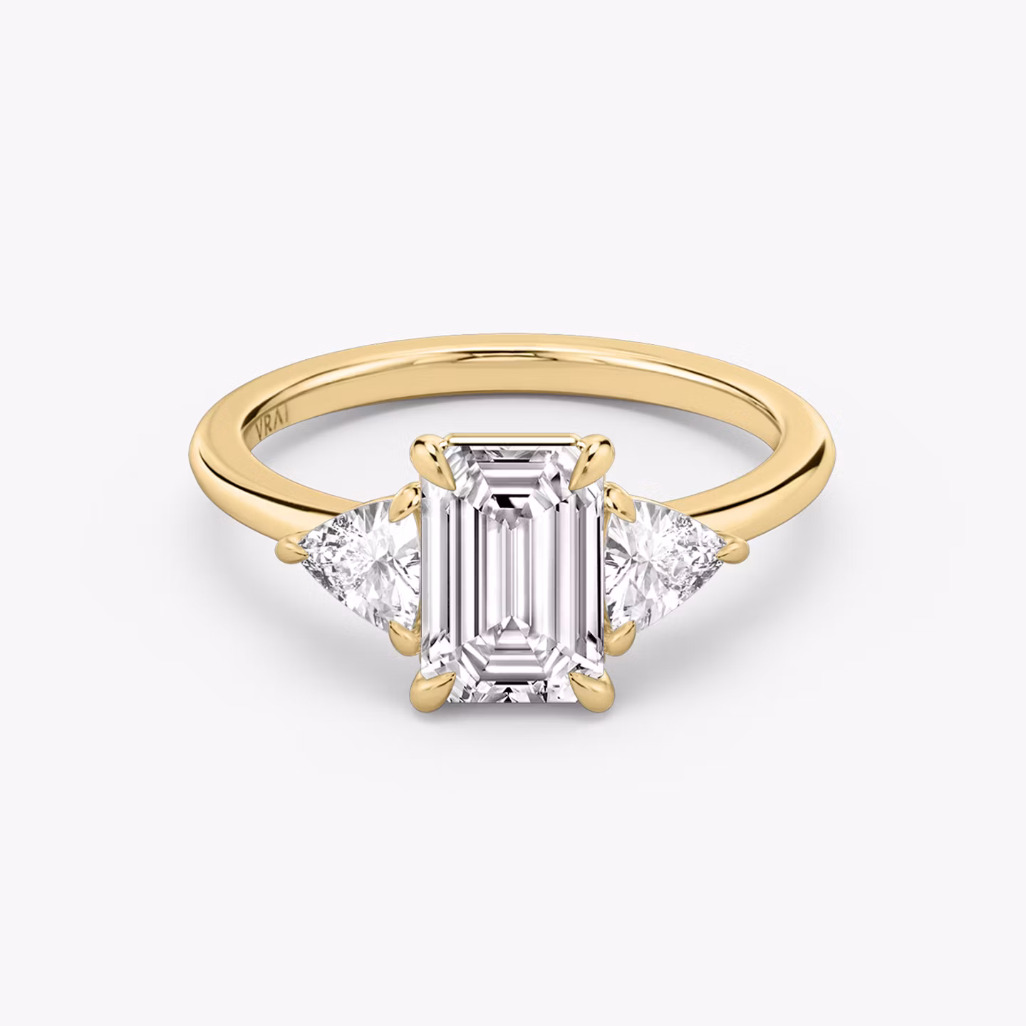 The Three Stone | Emerald | 18k | Yellow Gold | bandAccent: Plain | sideStoneCarat: 0.25ct | sideStoneShape: Trillion | diamondOrientation: vertical | caratWeight: other