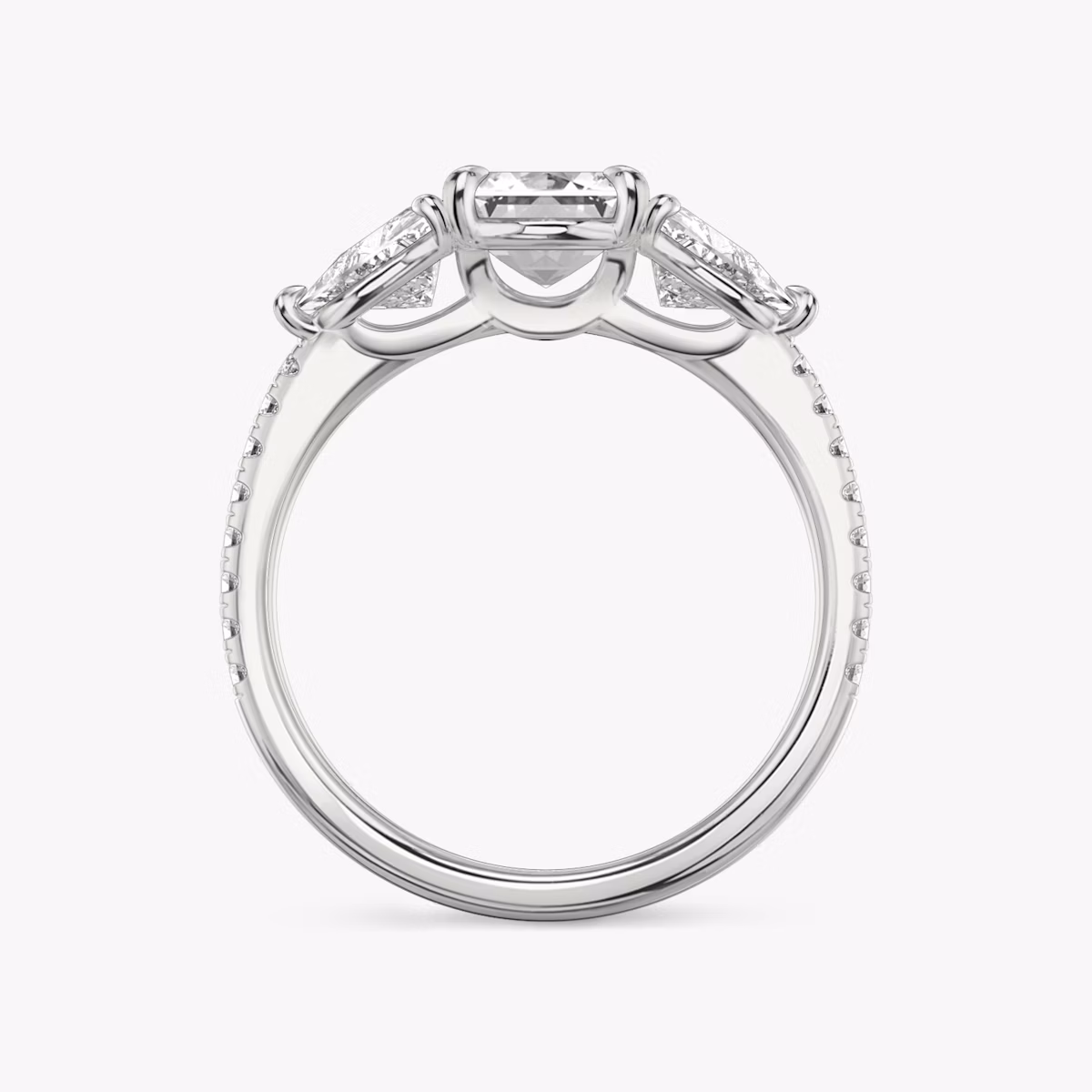 The Three Stone | Emerald | Platinum | bandAccent: Pavé | sideStoneCarat: 0.50ct | sideStoneShape: Trillion | diamondOrientation: vertical | caratWeight: other