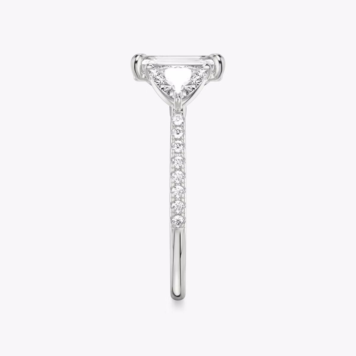 The Three Stone | Emerald | Platinum | bandAccent: Pavé | sideStoneCarat: 0.50ct | sideStoneShape: Trillion | diamondOrientation: vertical | caratWeight: other