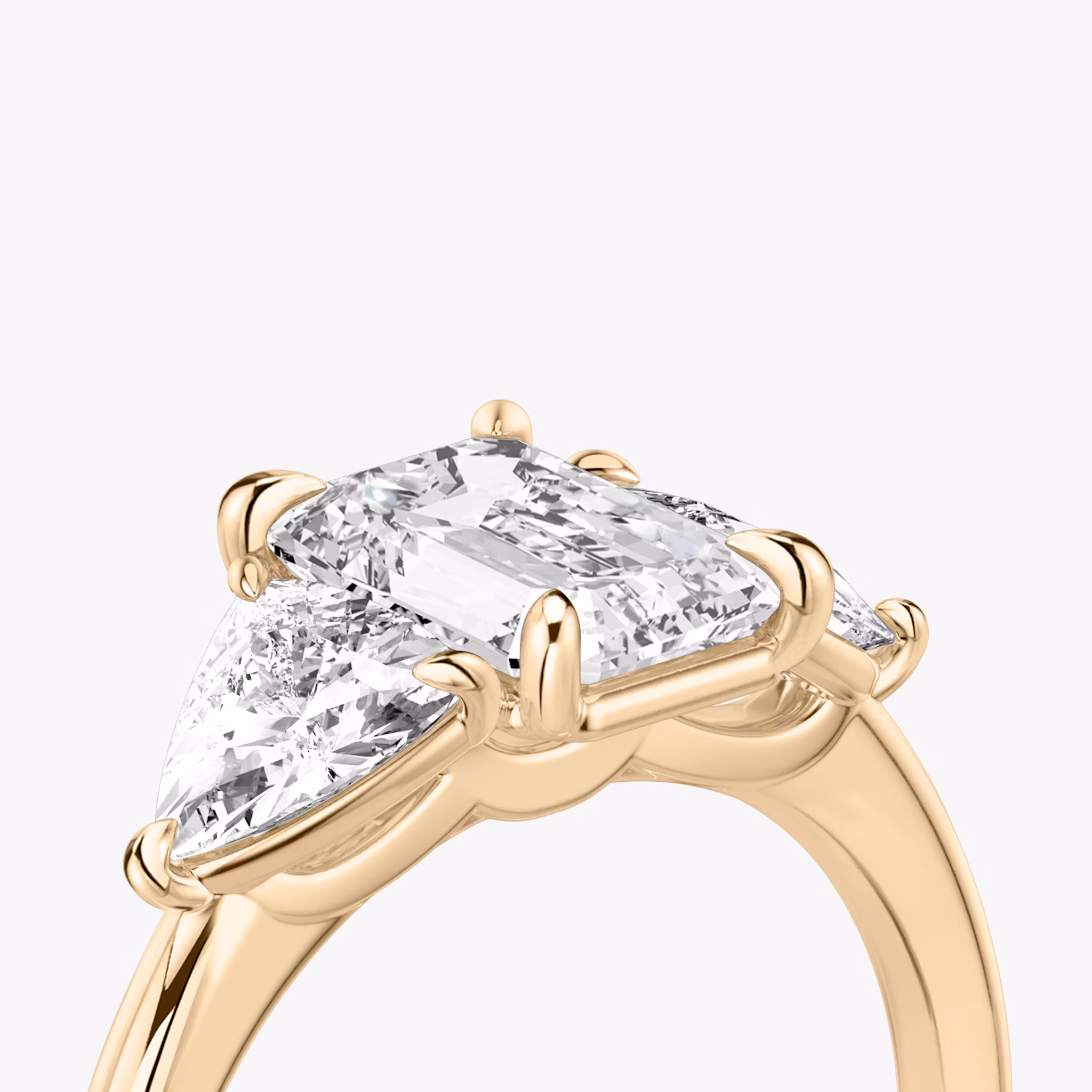 The Three Stone | Emerald | 14k | Rose Gold | bandAccent: Plain | sideStoneCarat: 0.50ct | sideStoneShape: Trillion | diamondOrientation: vertical | caratWeight: other