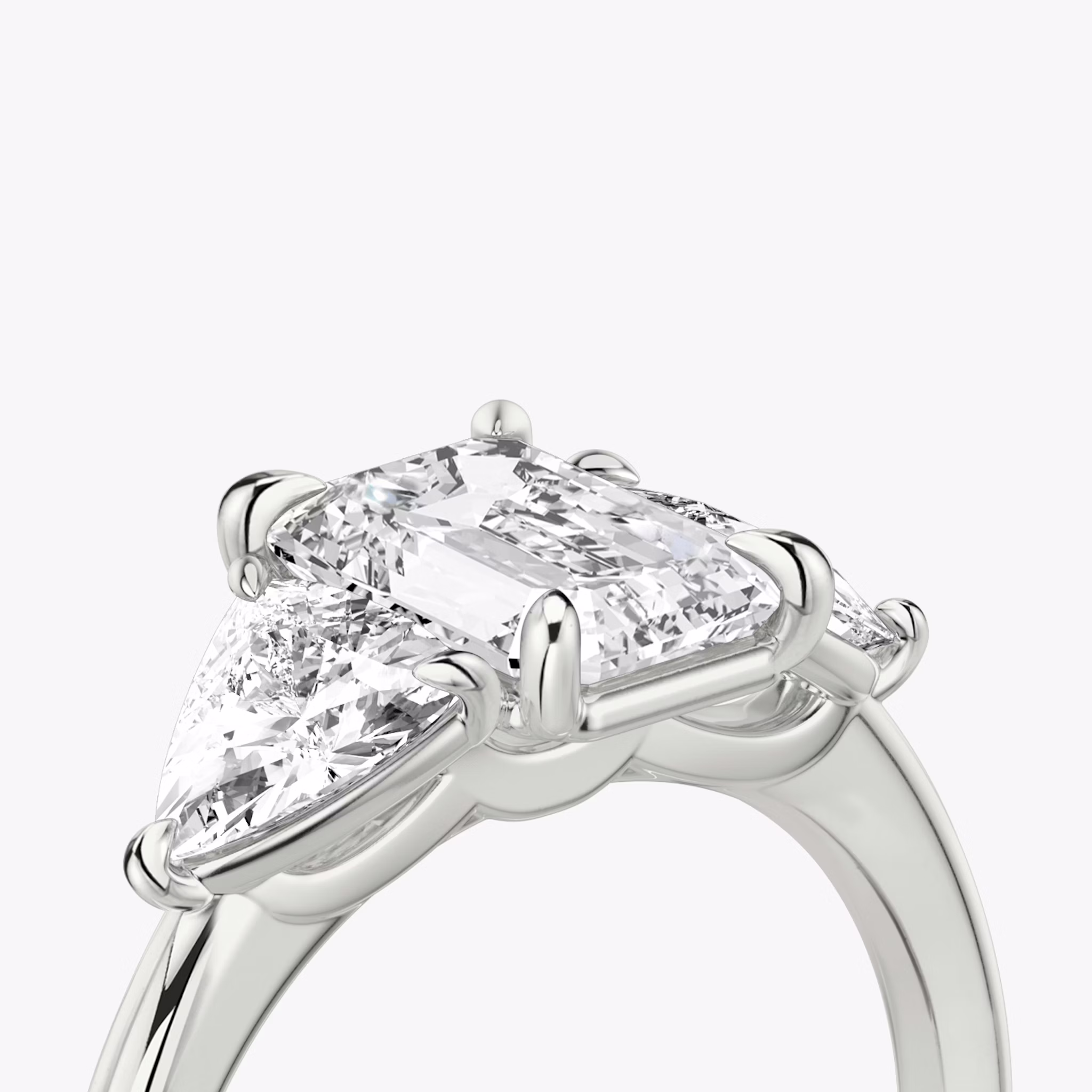 The Three Stone | Emerald | 18k | White Gold | bandAccent: Plain | sideStoneCarat: 0.50ct | sideStoneShape: Trillion | diamondOrientation: vertical | caratWeight: other