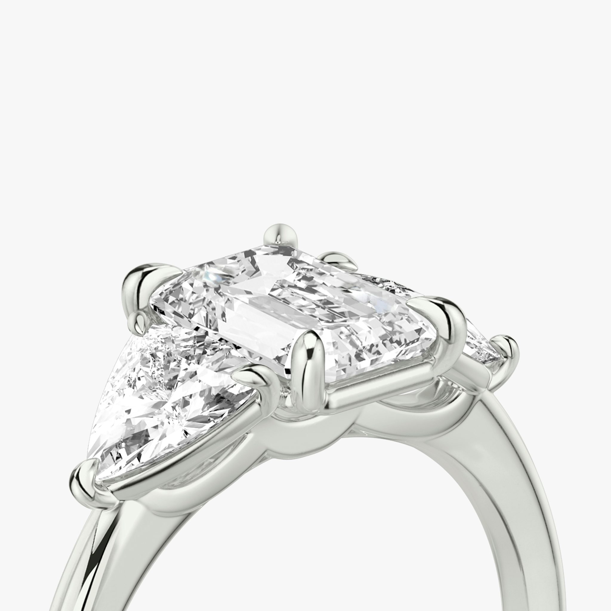 The Three Stone | Emerald | 18k | White Gold | bandAccent: Plain | sideStoneCarat: 0.50ct | sideStoneShape: Trillion | diamondOrientation: vertical | caratWeight: other