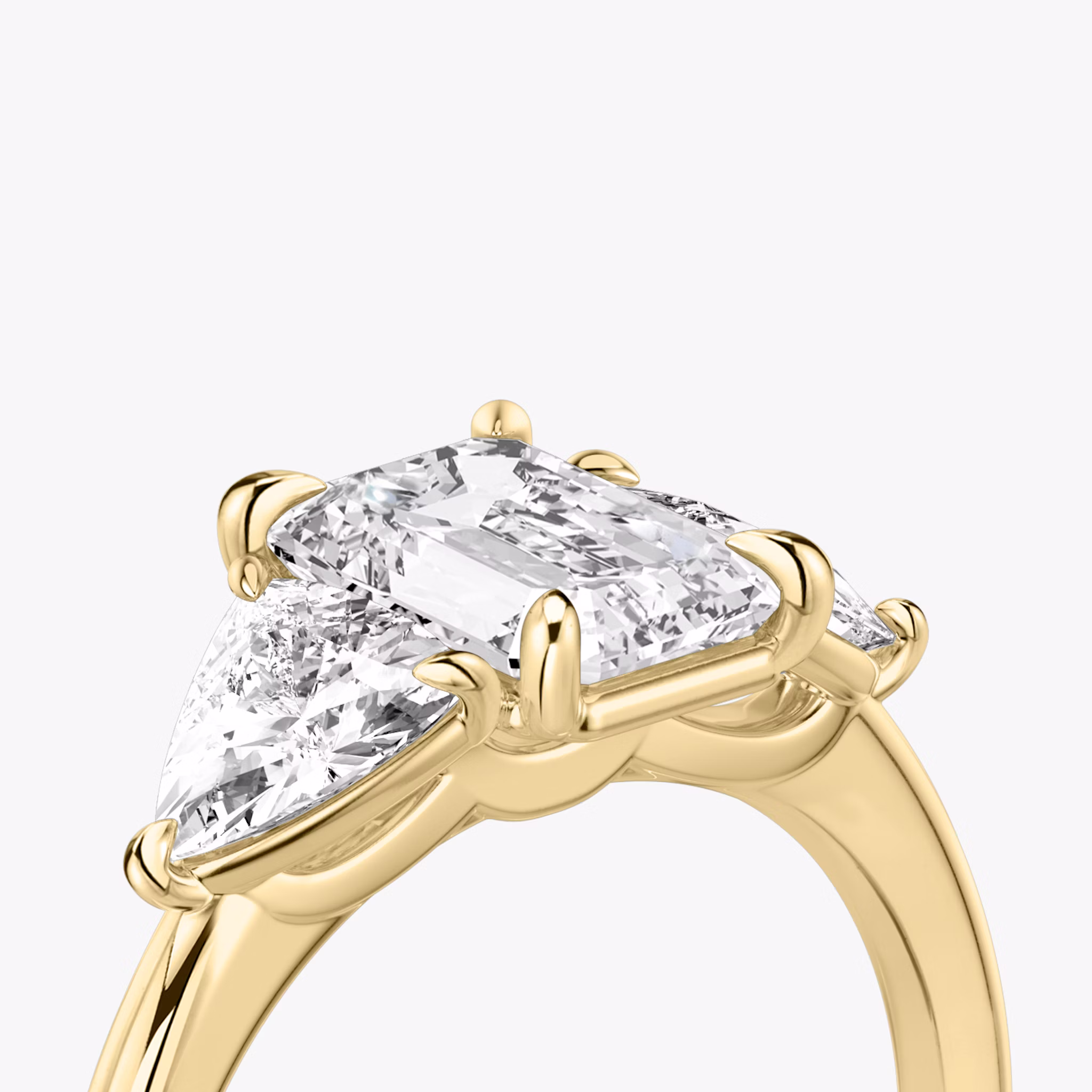 The Three Stone | Emerald | 18k | Yellow Gold | bandAccent: Plain | sideStoneCarat: 0.50ct | sideStoneShape: Trillion | diamondOrientation: vertical | caratWeight: other