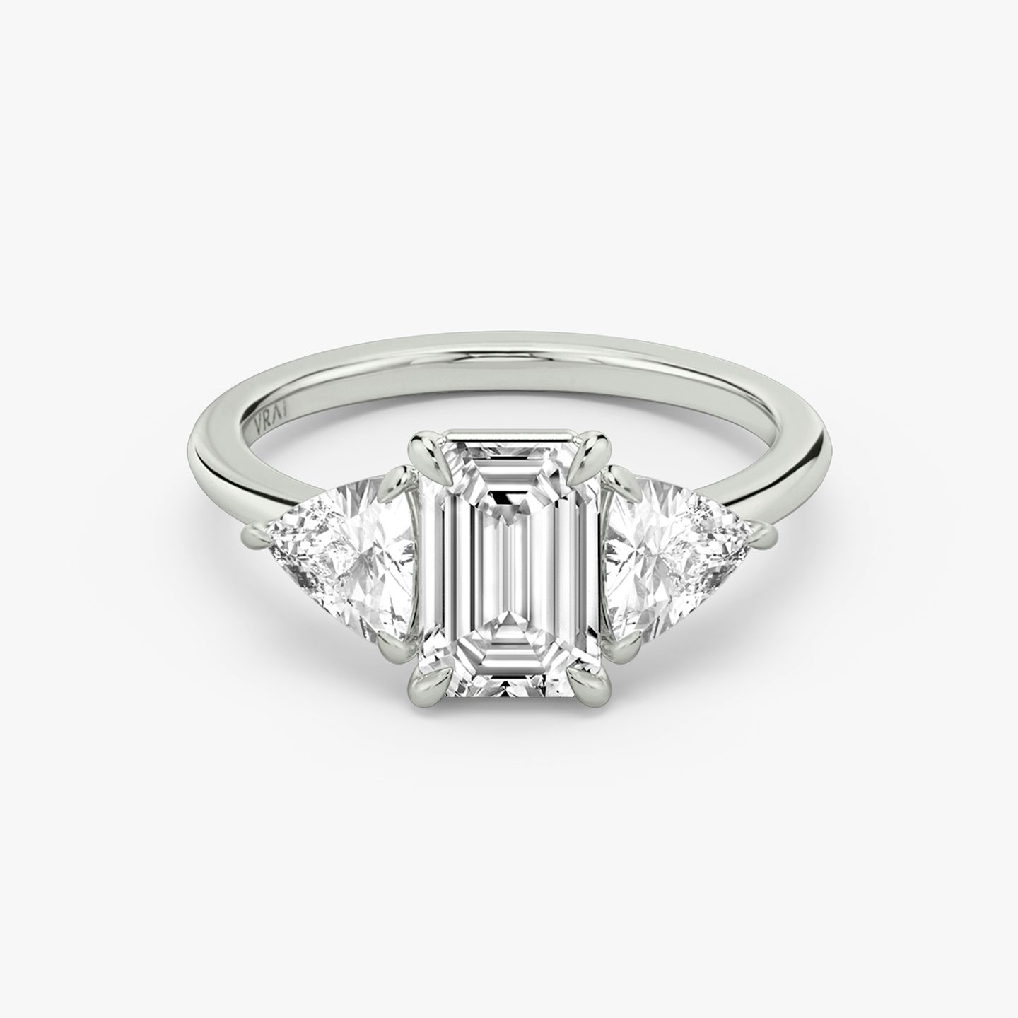 The Three Stone | Emerald | 18k | White Gold | bandAccent: Plain | sideStoneCarat: 0.50ct | sideStoneShape: Trillion | diamondOrientation: vertical | caratWeight: other