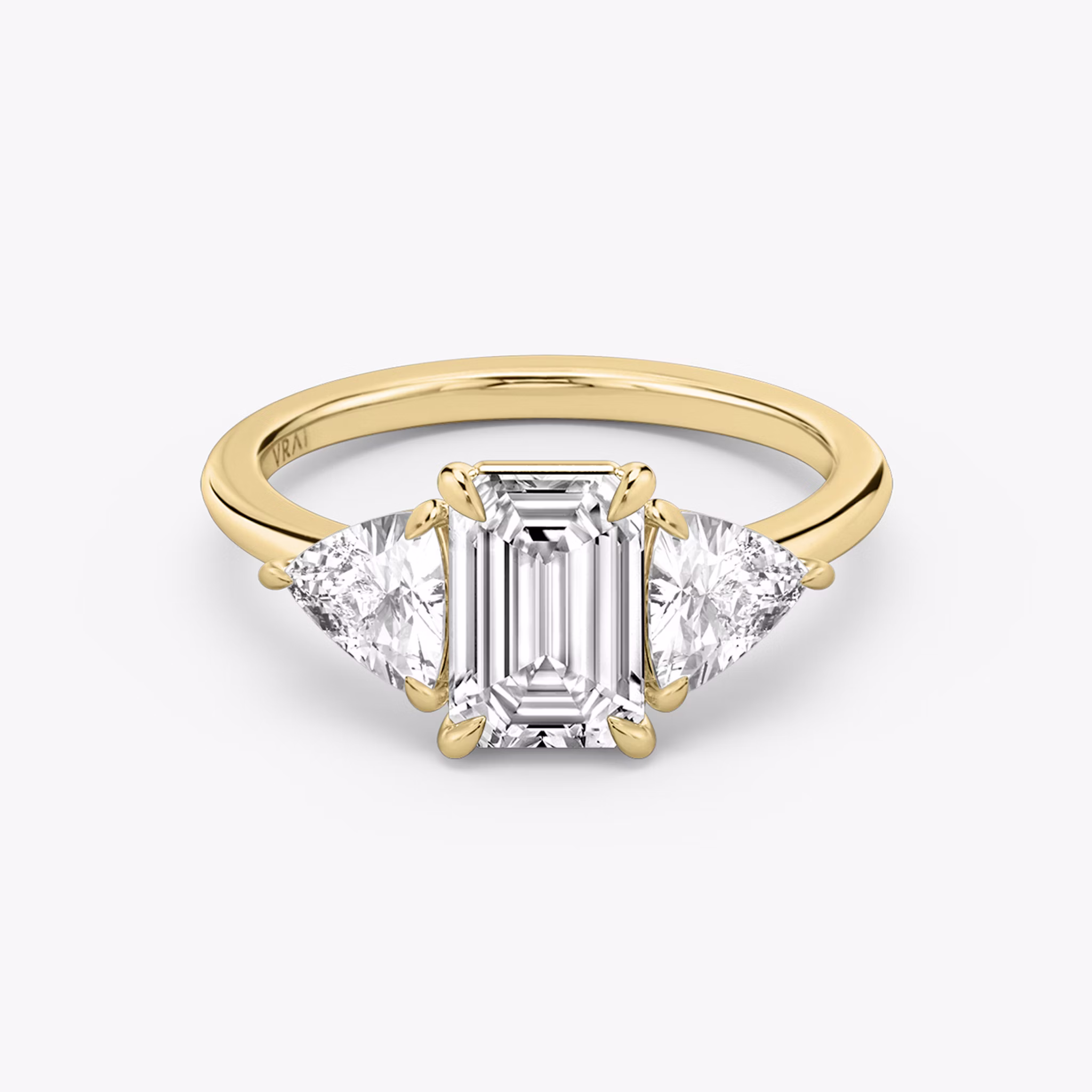 The Three Stone | Emerald | 18k | Yellow Gold | bandAccent: Plain | sideStoneCarat: 0.50ct | sideStoneShape: Trillion | diamondOrientation: vertical | caratWeight: other