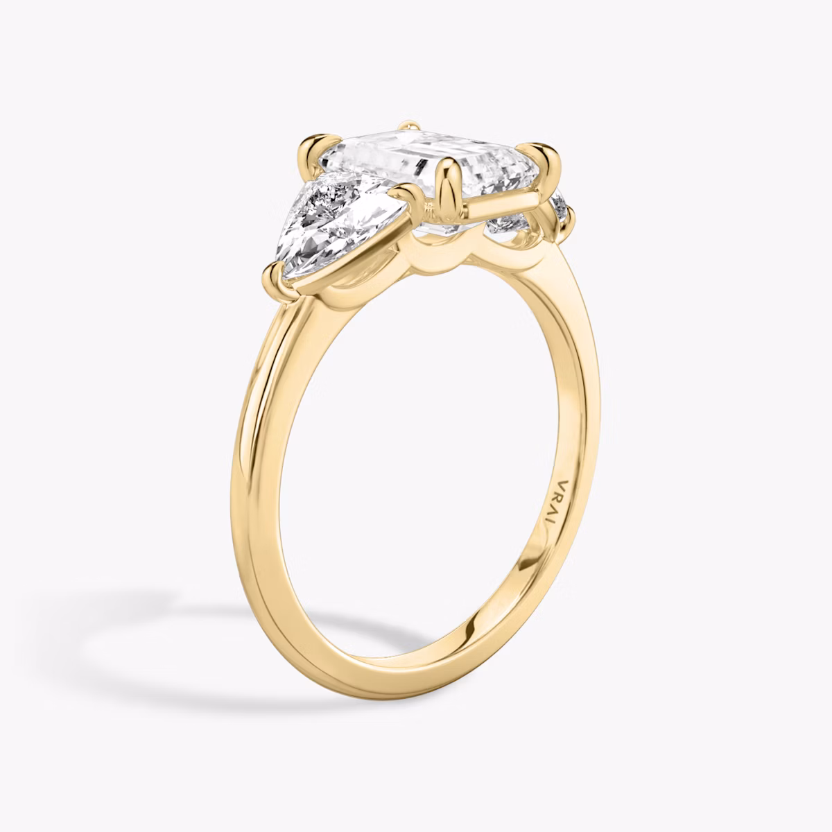 The Three Stone | Emerald | 18k | Yellow Gold | bandAccent: Plain | sideStoneCarat: 0.50ct | sideStoneShape: Trillion | diamondOrientation: vertical | caratWeight: other
