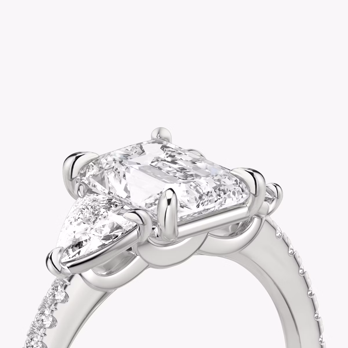 The Three Stone | Radiant | Platinum | bandAccent: Pavé | sideStoneCarat: 0.25ct | sideStoneShape: Trillion | diamondOrientation: vertical | caratWeight: other