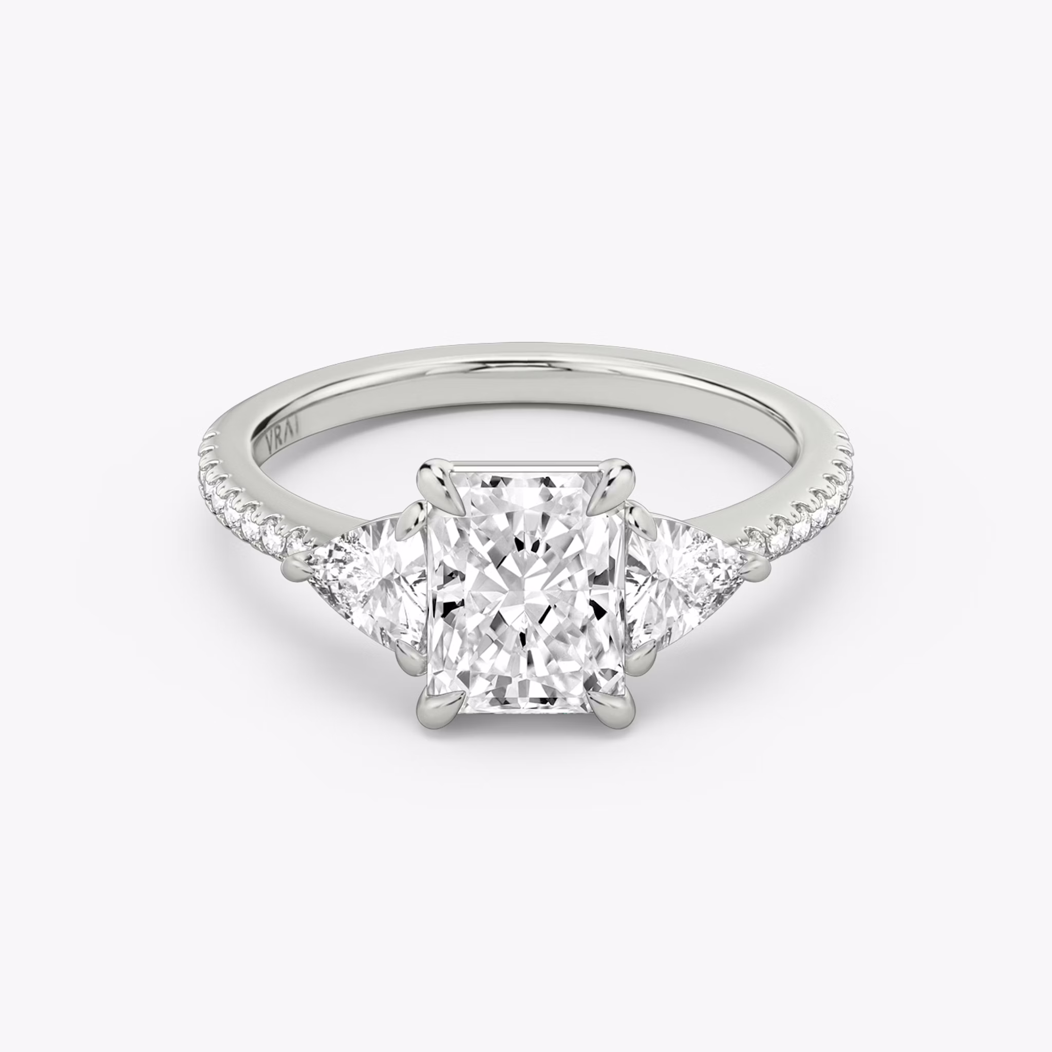 The Three Stone | Radiant | Platinum | bandAccent: Pavé | sideStoneCarat: 0.25ct | sideStoneShape: Trillion | diamondOrientation: vertical | caratWeight: other
