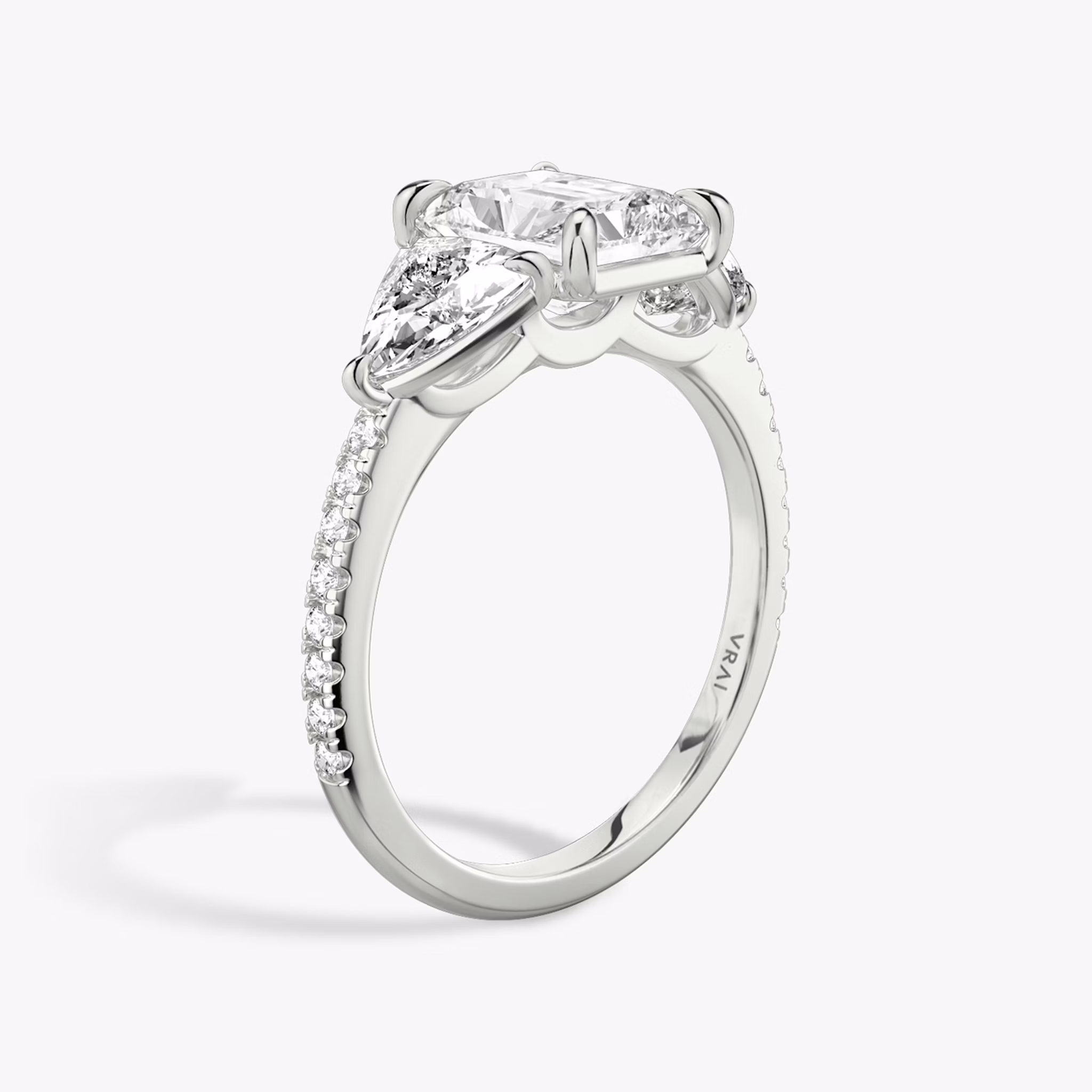 The Three Stone | Radiant | 18k | White Gold | bandAccent: Pavé | sideStoneCarat: 0.50ct | sideStoneShape: Trillion | diamondOrientation: vertical | caratWeight: other